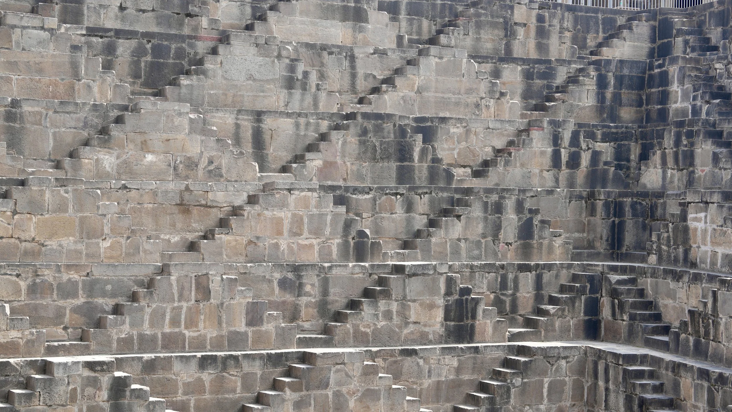 Deep stepwell at Abhaneri India with symmetrical stone terraces