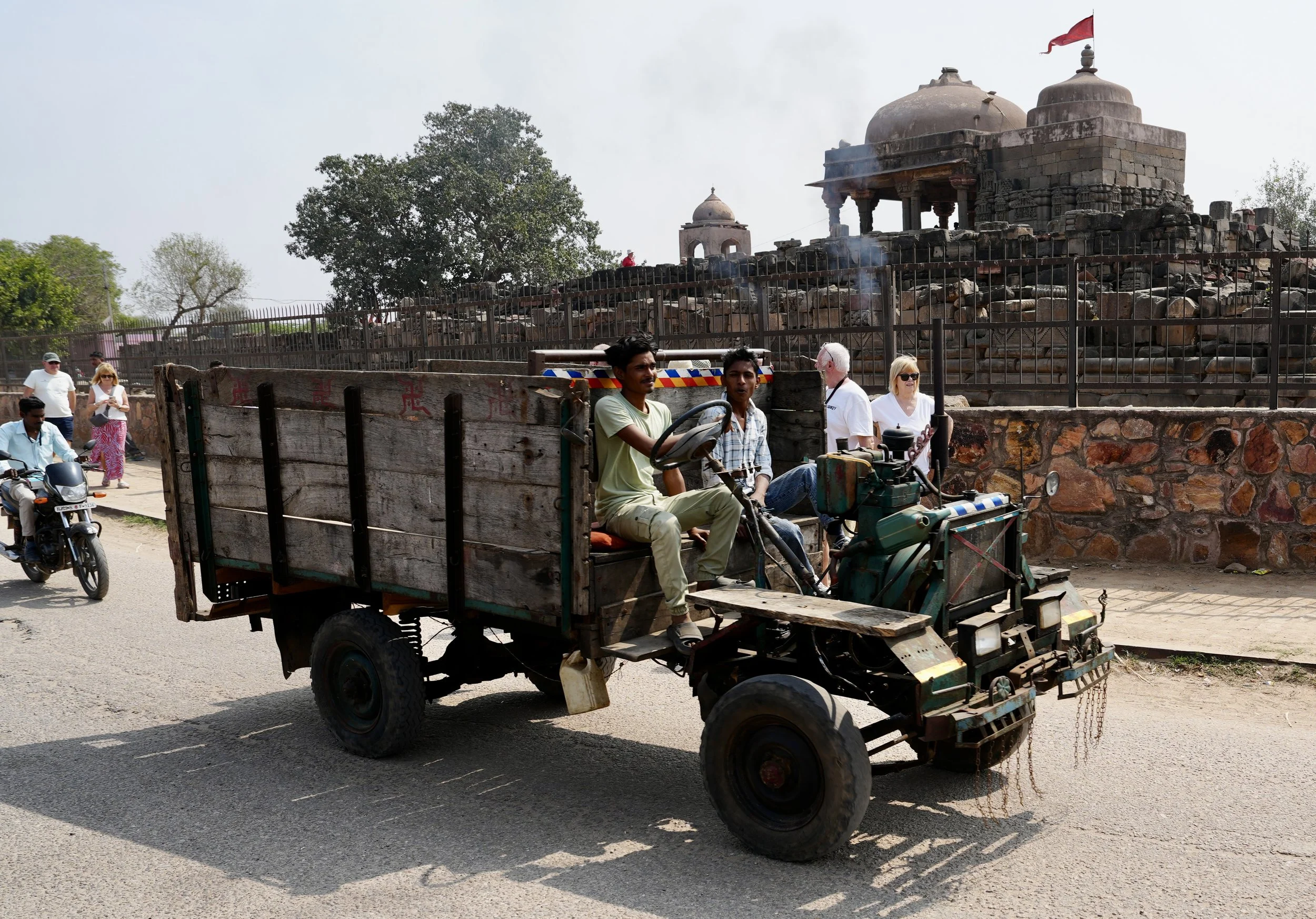 Tractor pulling trailer with passengers on road in rural Rajasthan India
