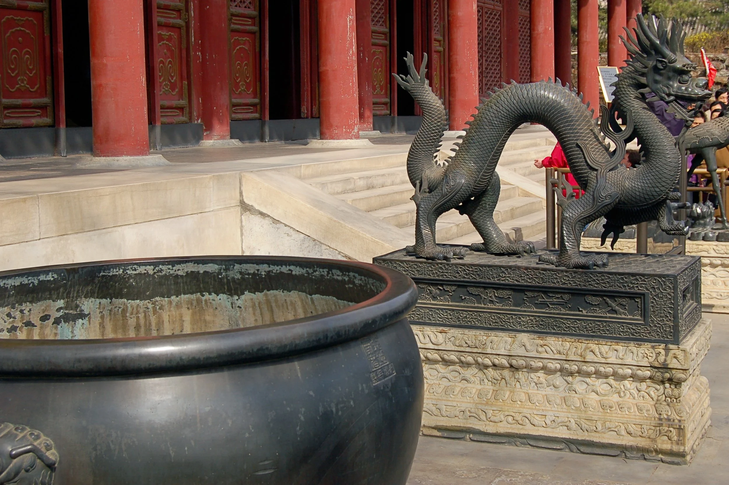 Bronze incense burner and decorative metalwork in a courtyard at the Summer Palace, showing ornate detailing and weathered surfaces.