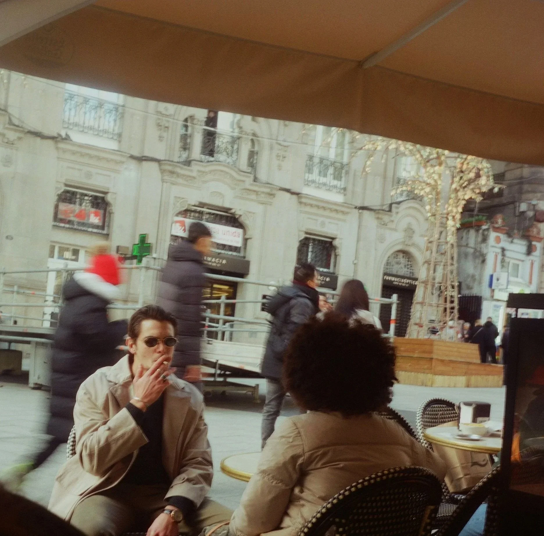 Candid street photography shot on vintage medium format film. Capturing the organic chaos of human behavior in a public square in Vigo, Spain.