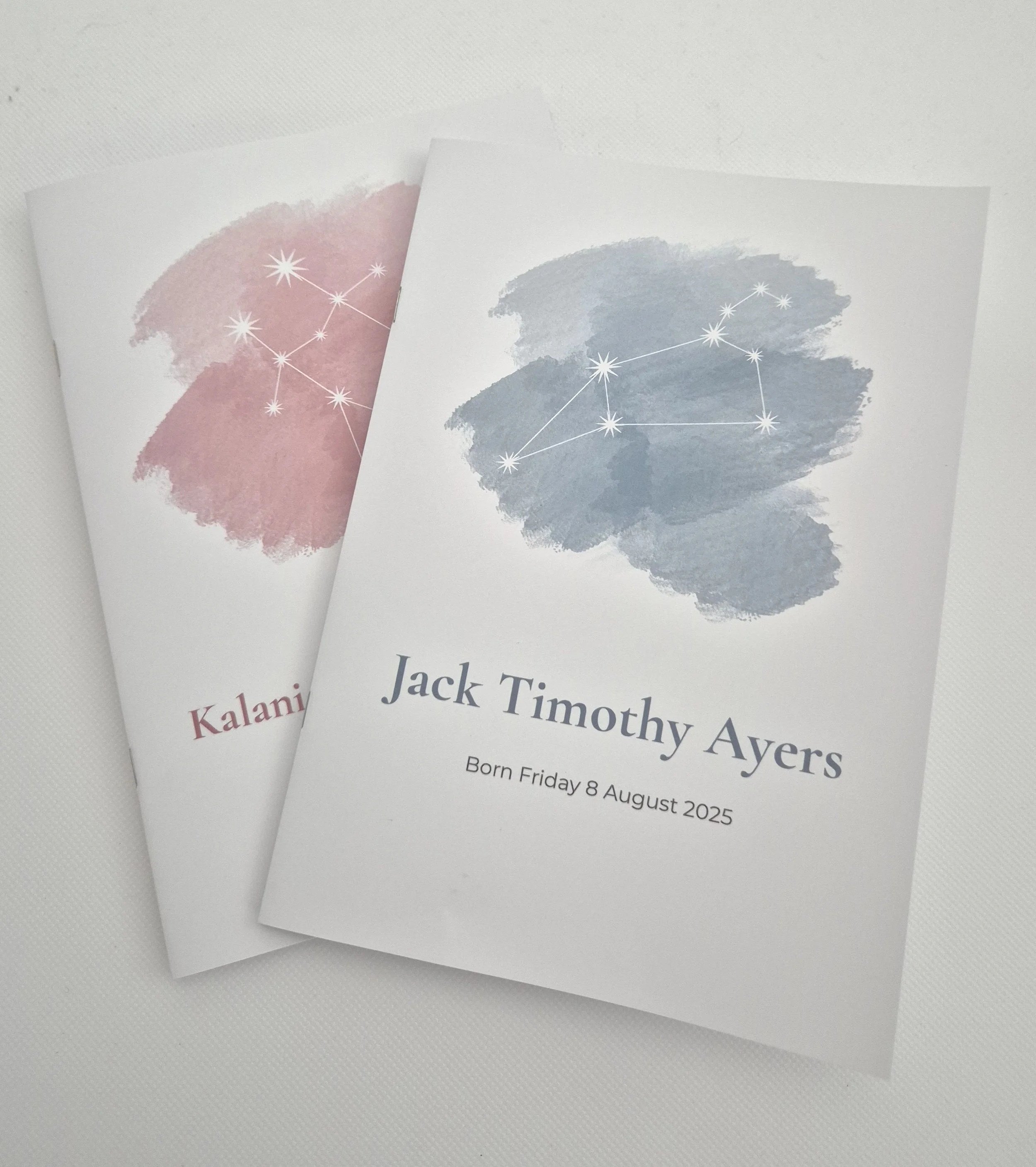 Examples of newborn astrology books with your baby's constellation, name and date of birth on the cover.