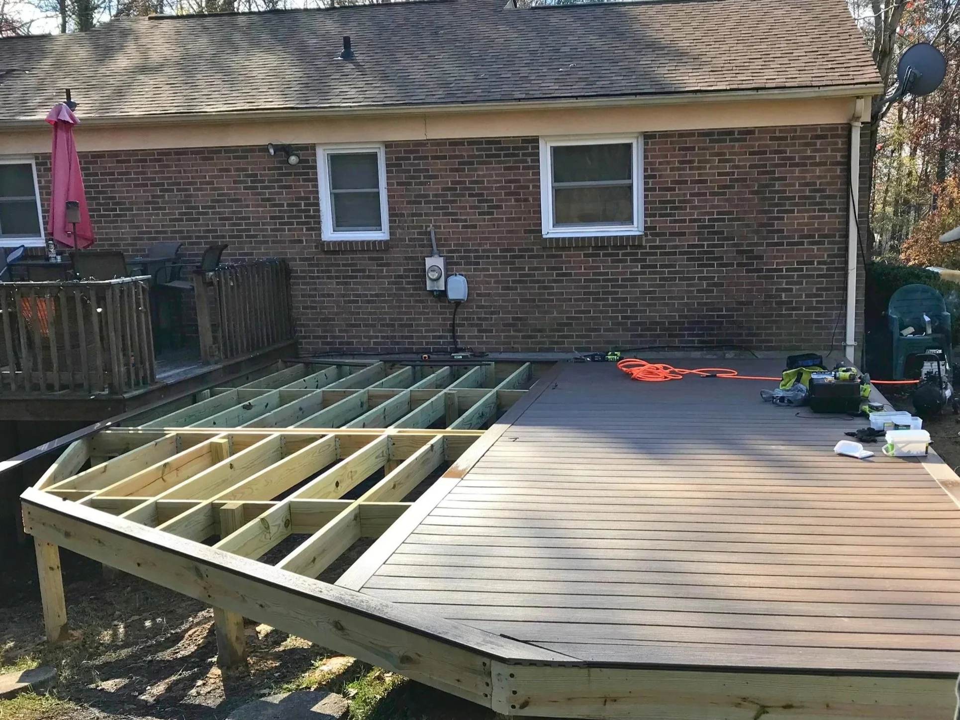 New deck framing under construction behind a residential home in Danville, Virginia.