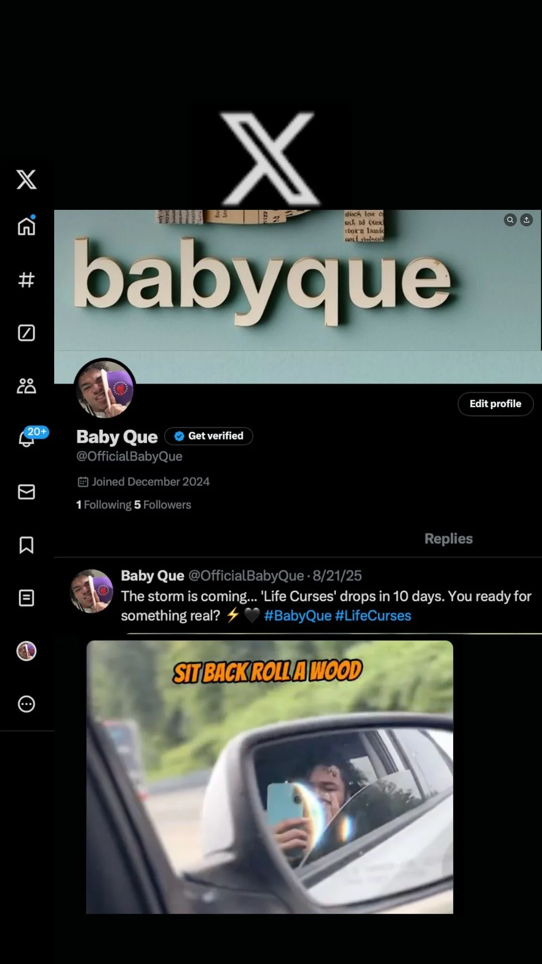 A social media profile page for Baby Que, with a cover photo displaying the word 'babyque' in large letters on a light blue background. The profile shows a small circular profile picture of a person holding a purple flag, with a verified badge. The latest post contains a photo of a young person taking a selfie in a car's side mirror with the text 'SIT BACK ROLL A WOOD' in orange letters at the top.