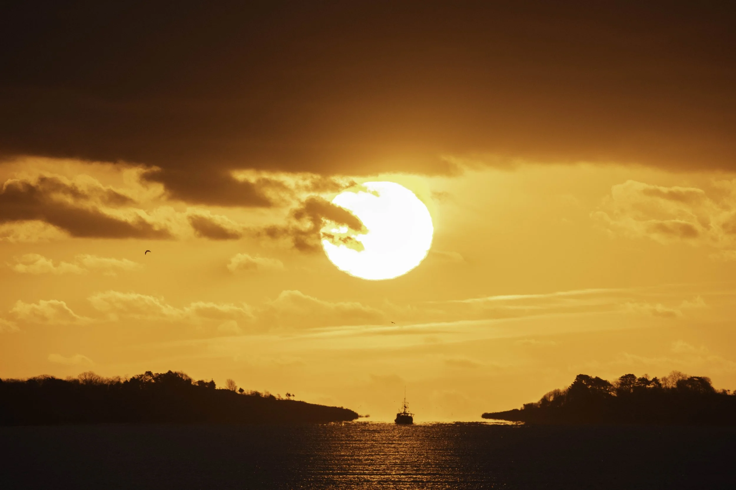 The Sun rising over the fishing boat as they head out for the day.
