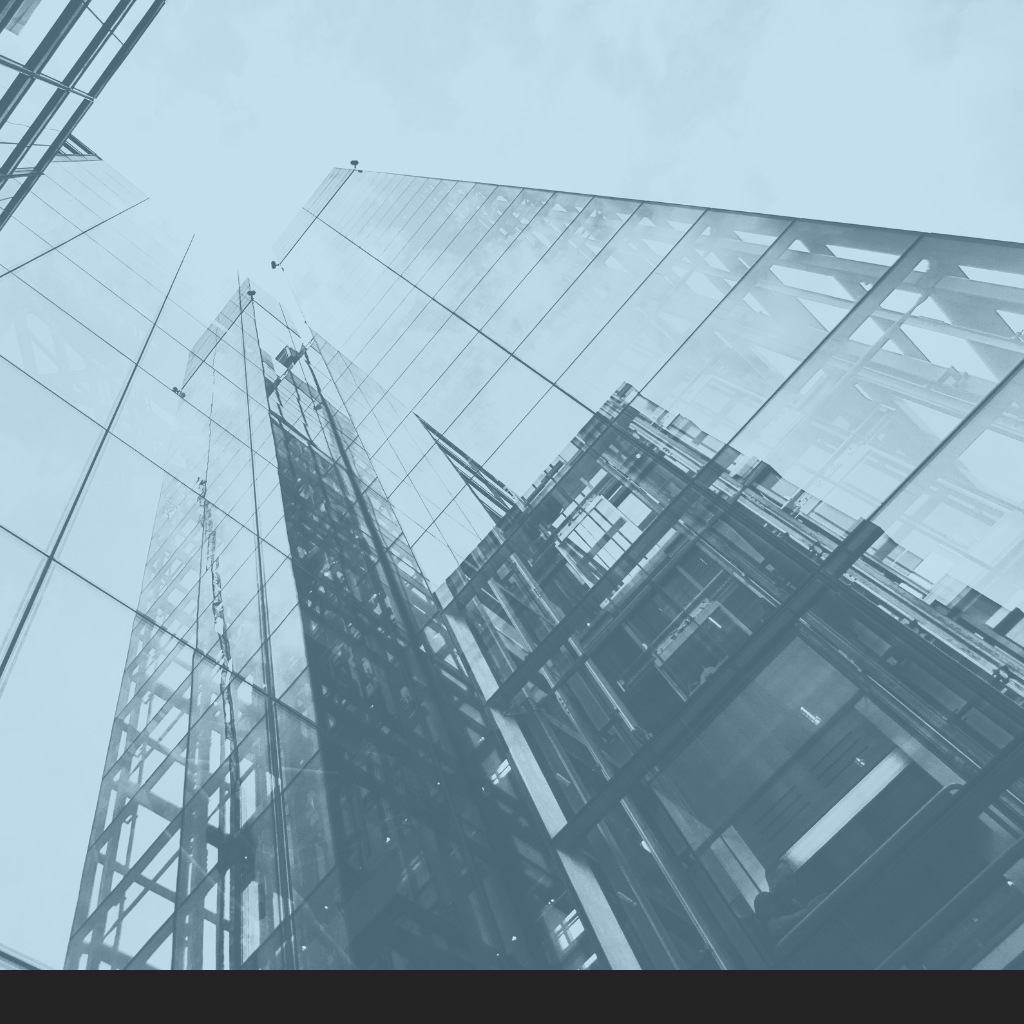 Low-angle view of modern glass skyscrapers reflecting the sky.