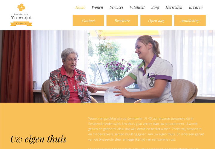 Een verzorgster helpt een oudere vrouw met een navelslang door haar steriele hand te plaatsen, terwijl ze lachen samen in een comfortabele woonkamer met grote ramen en bloemen.