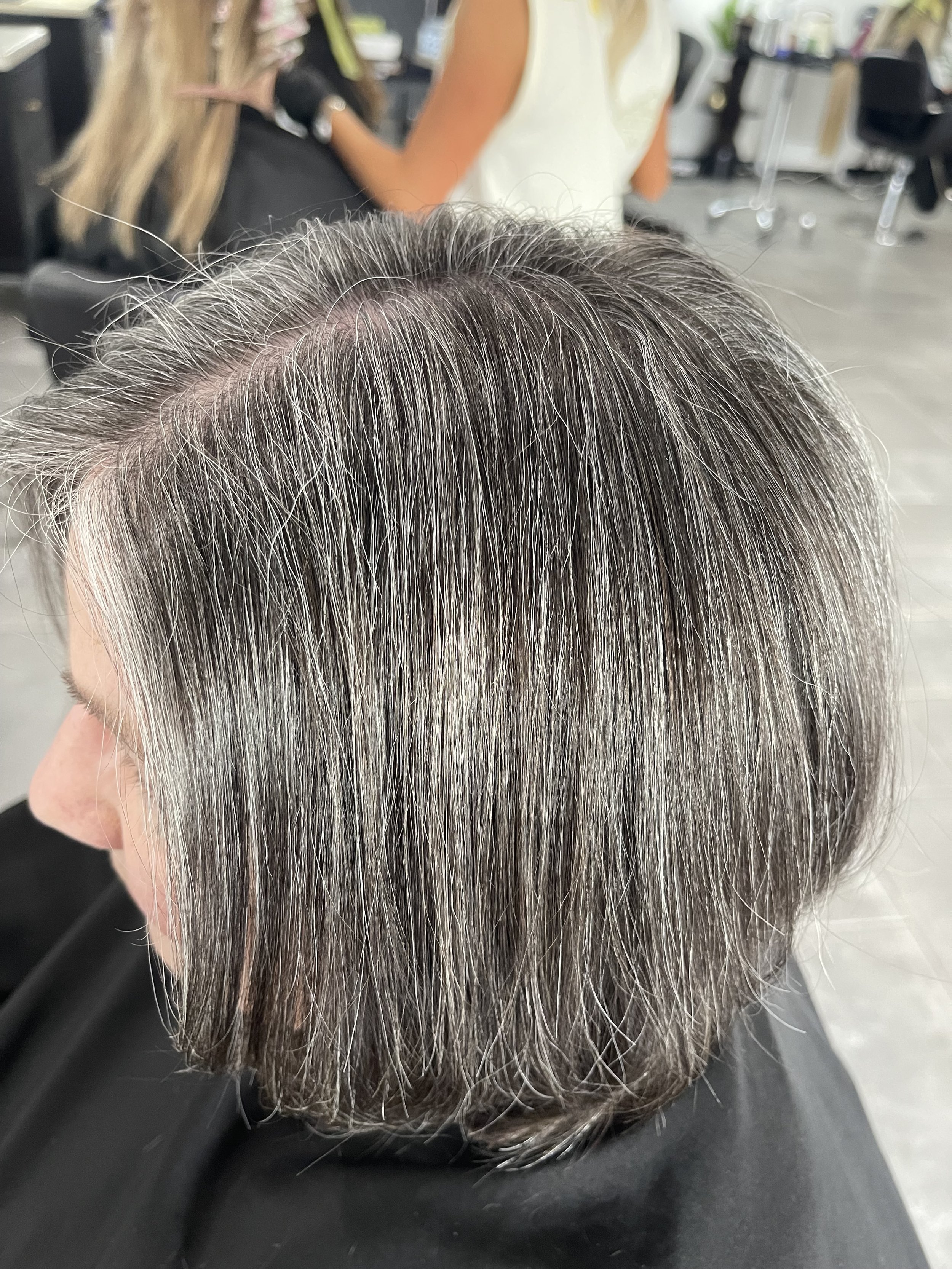 Woman with a grey bob haircut.