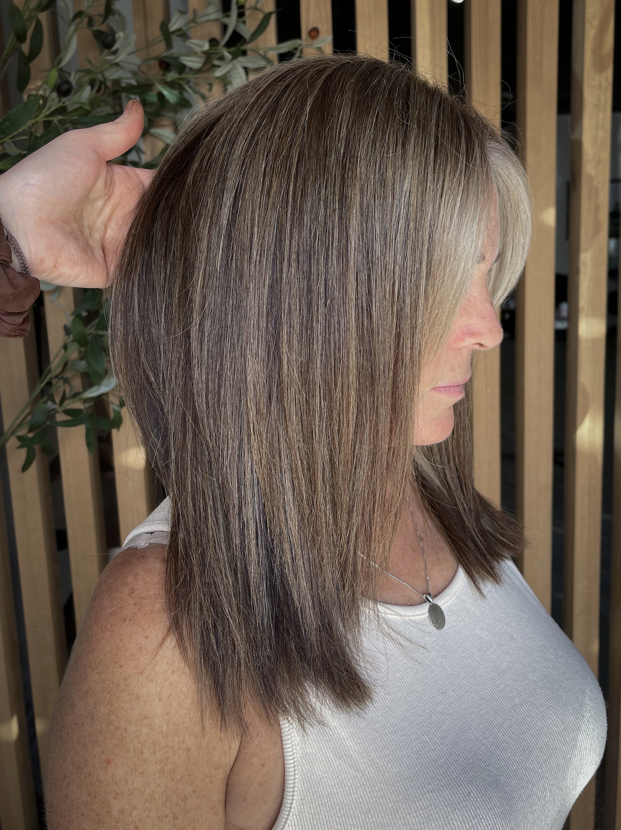 Grey Blending client who is naturally dark brunette and has ashy blonde highlights to help soften her grew grow out. 
