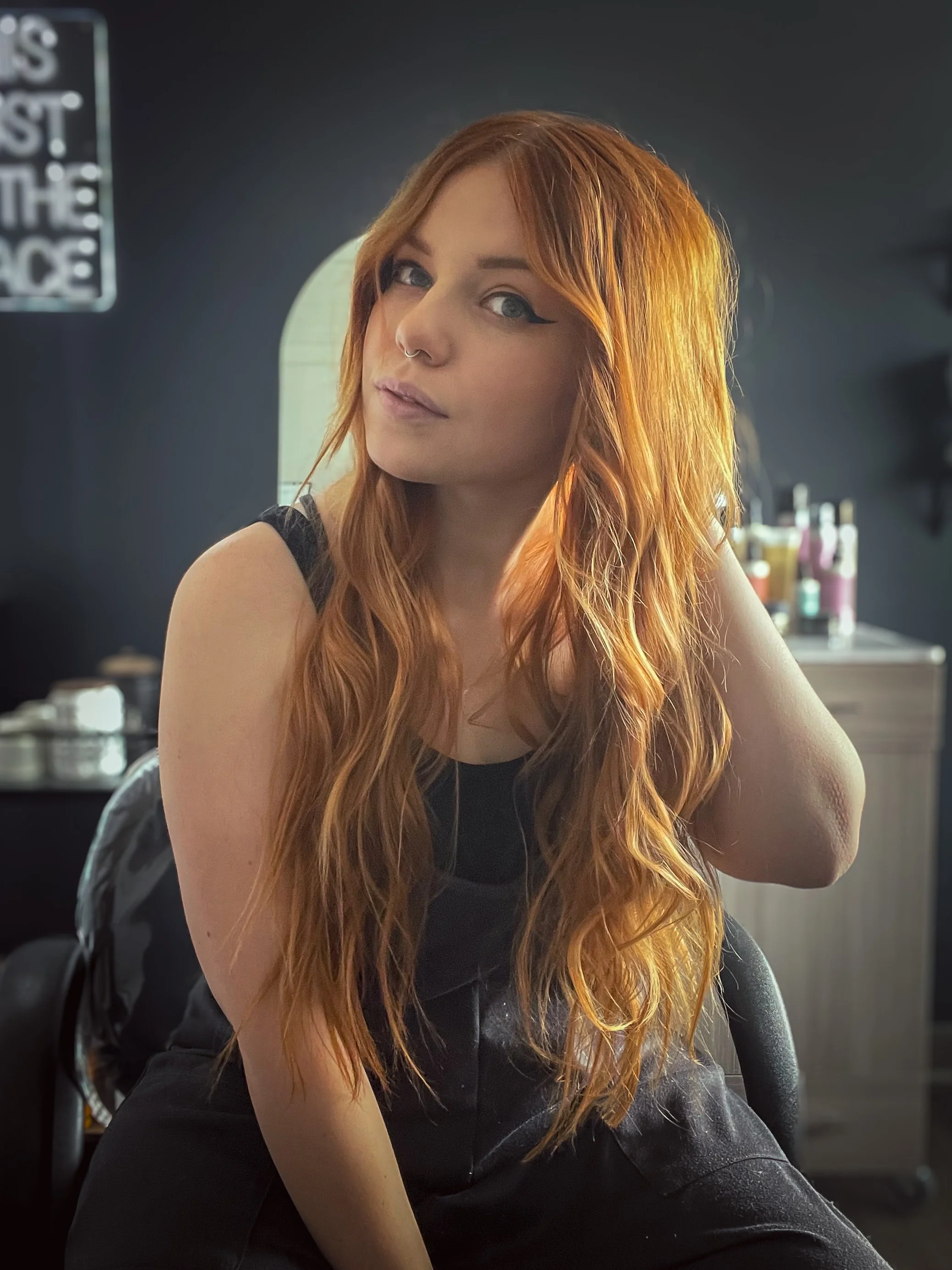 Hairstylist posing in her private salon suite.