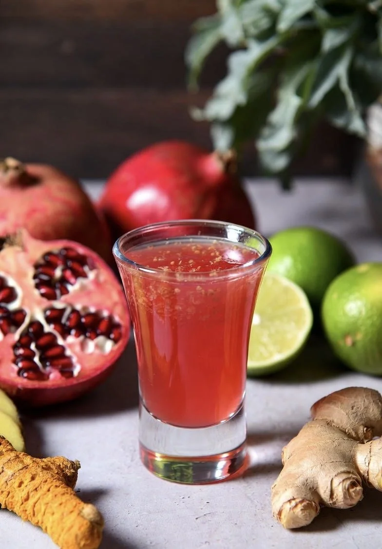 alt="VivAxis red pomegranate wellness shot with lime, turmeric, ginger, and herbs for antioxidants"