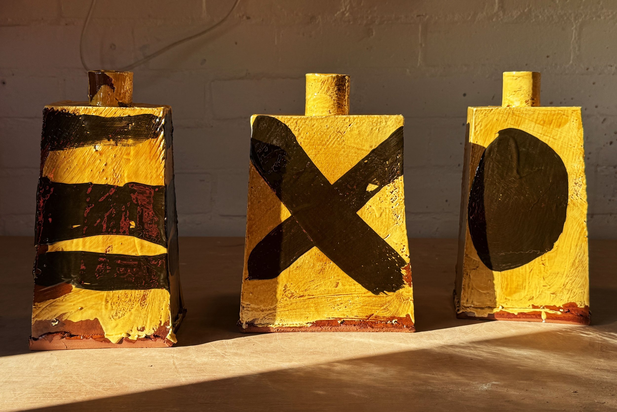 Slap built bud vases, super textured and chunky. They make the perfect canvas for bold brushed slip decoration, with highly visible drips and streaks. I've started turning some of them into table lamps. 25-35cm high.