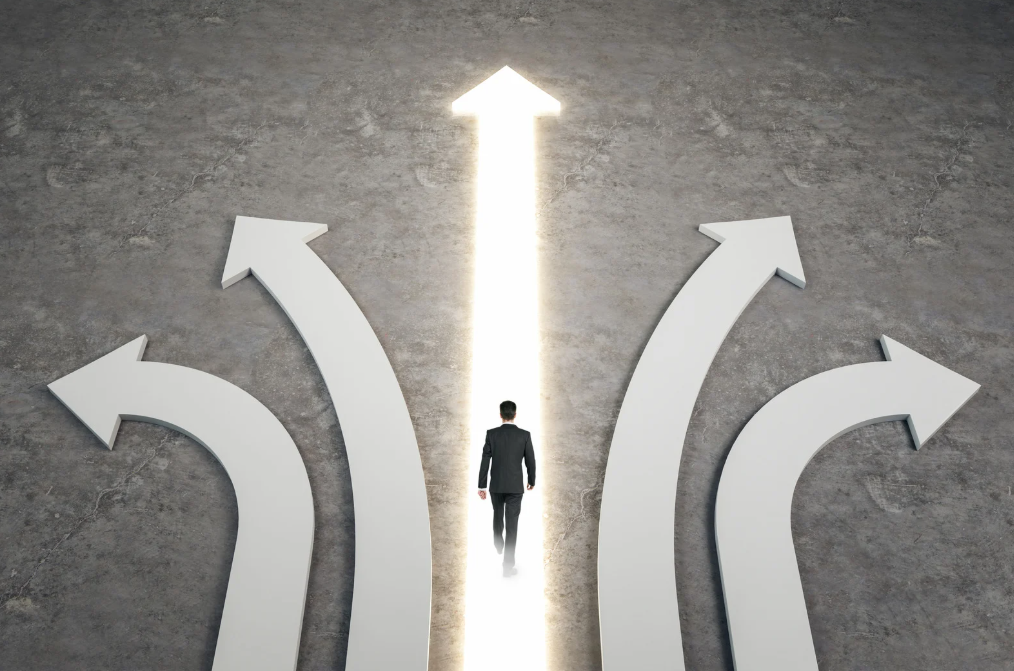 A man in a suit walking an illuminated path way with arrows showing other directions to go in.