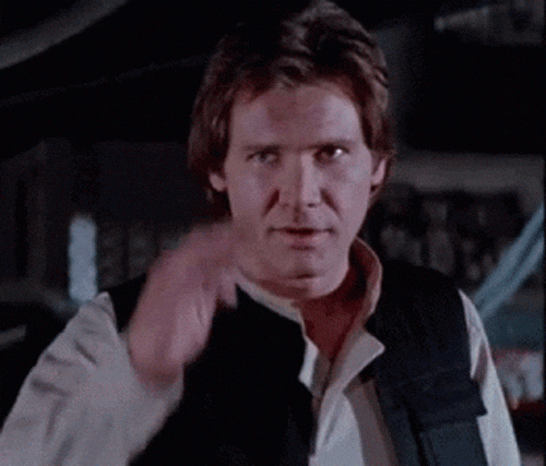 An animated gif of Han Solo from Star Wars making a salute gesture with his hand while looking at the camera