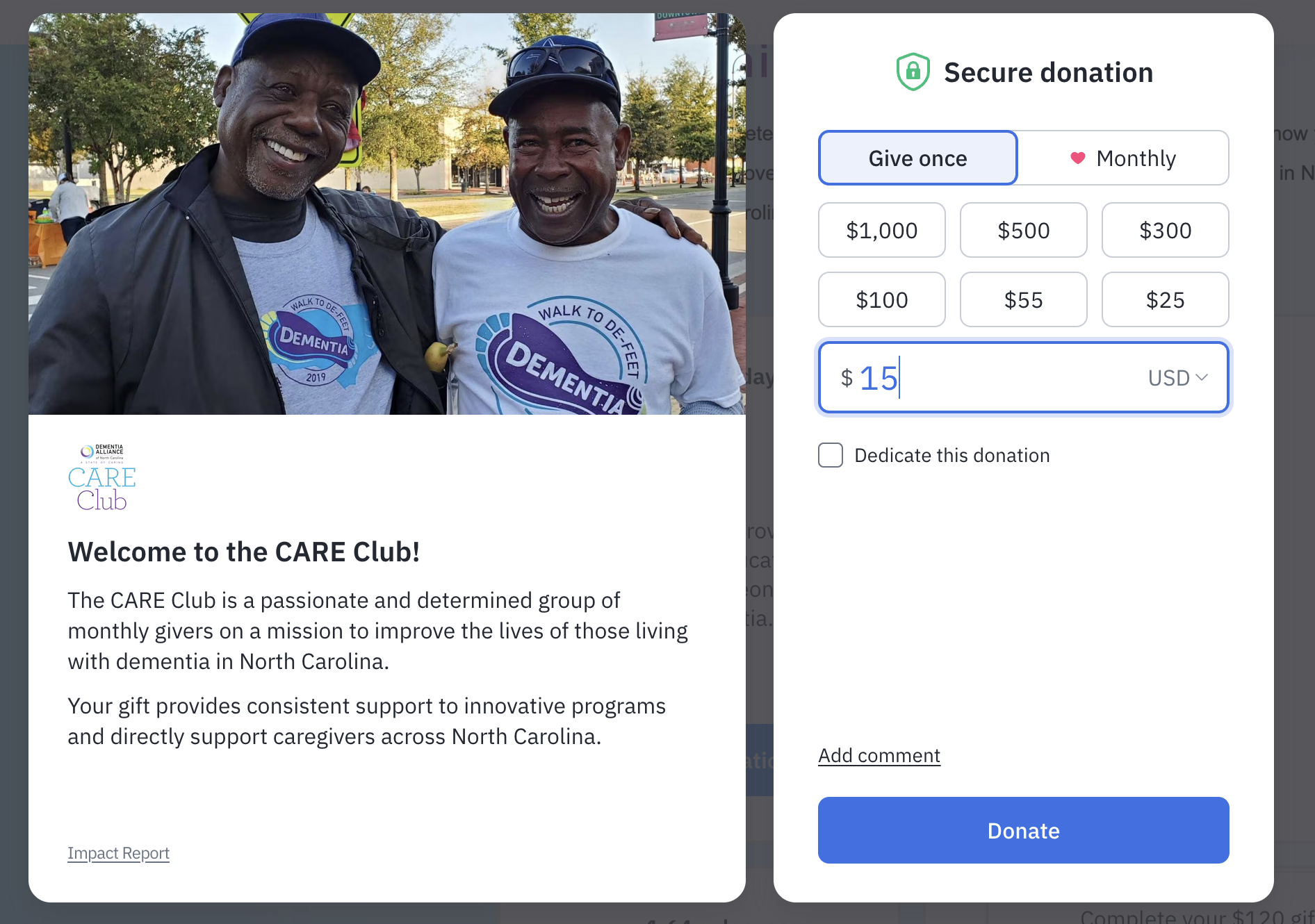 Two smiling men outdoors wearing T-shirts with 'Walk to DeFeet Dementia 2019' logo, standing close together with one man's arm around the other.