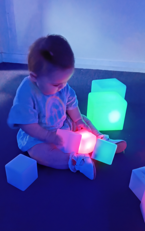 A child playing with sensory toys in our sensory room.