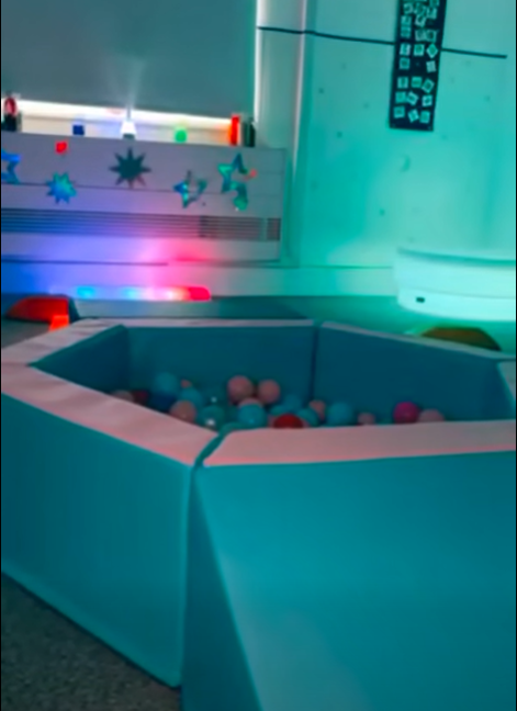 Sensory room, showing our filled ball pit, multi-coloured lights and textured toys