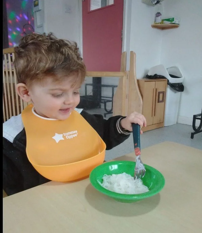 A young toddler enjoying a nutritious meal made by our chef