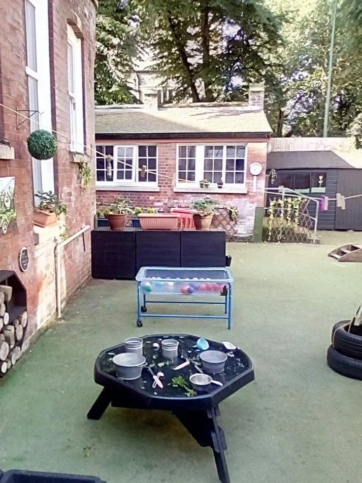 Outdoor area for toddlers and pre-schoolers at Sunrise, a variety of activities set up on our all weather garden.