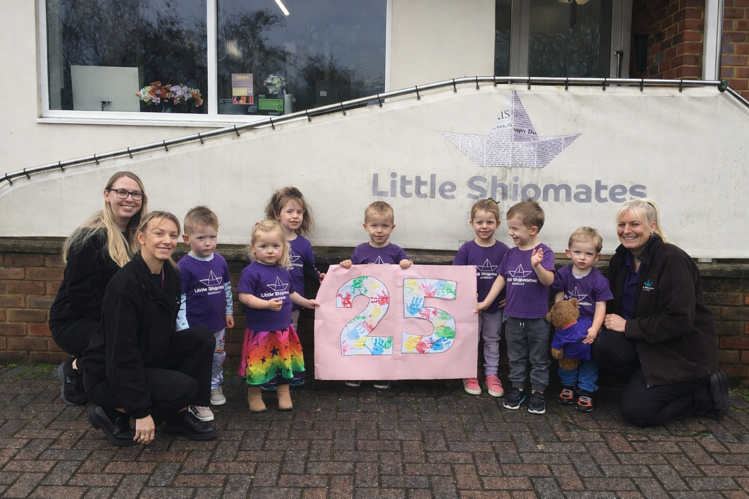 Staff and children celebrating 25th anniversary at Little Shipmates Day Nursery