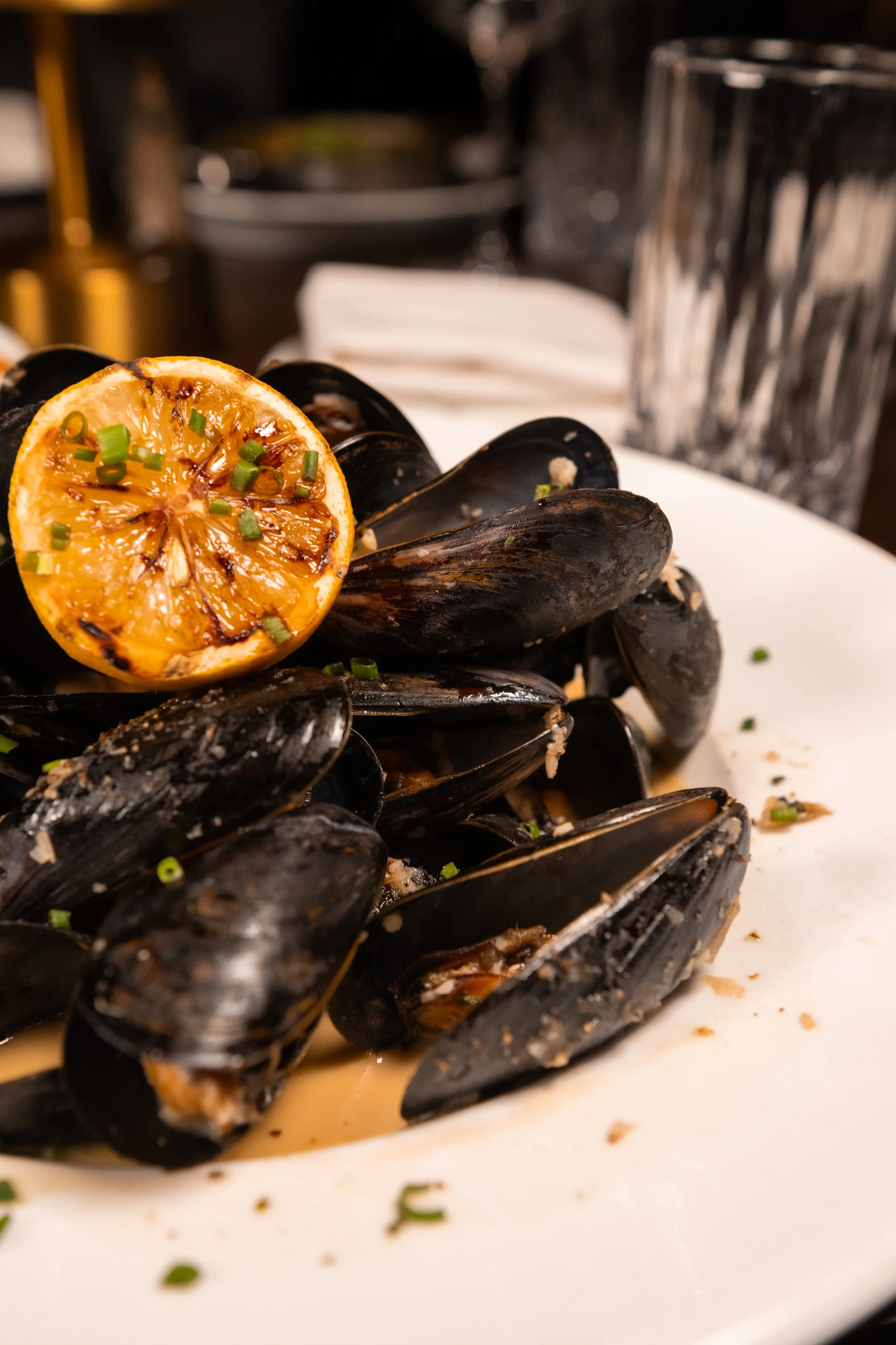 Steamed mussels with herbs and grilled lemon at The Hemingway Steakhouse.