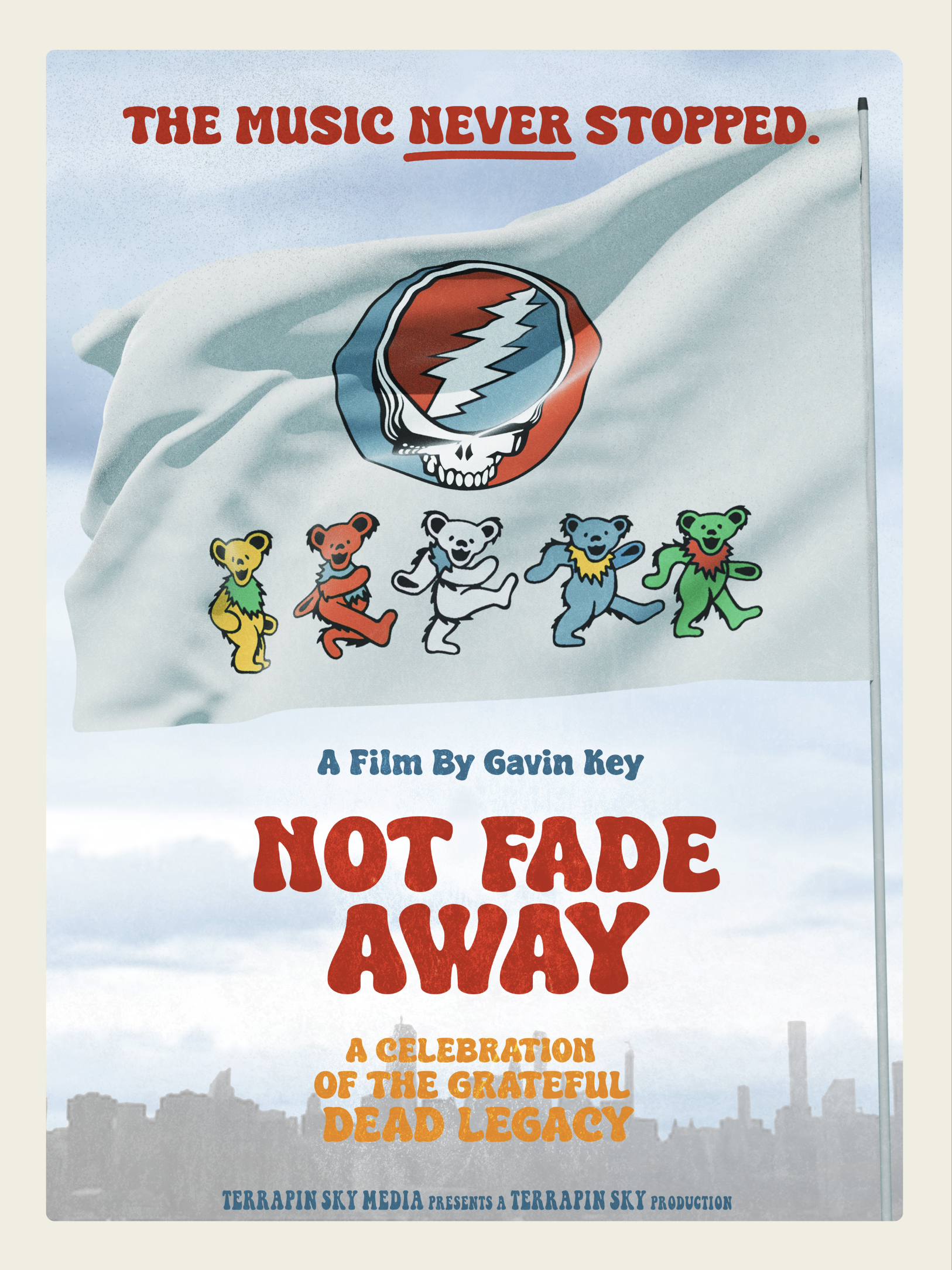 A film poster for 'Not Fade Away,' featuring a white flag with a Grateful Dead logo and dancing bears, with a city skyline in the background, and the tagline 'The music never stopped.'