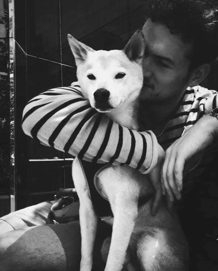 Jérémie Carlson with his dog Odie, the real-life inspiration for the story Coucou, Odie