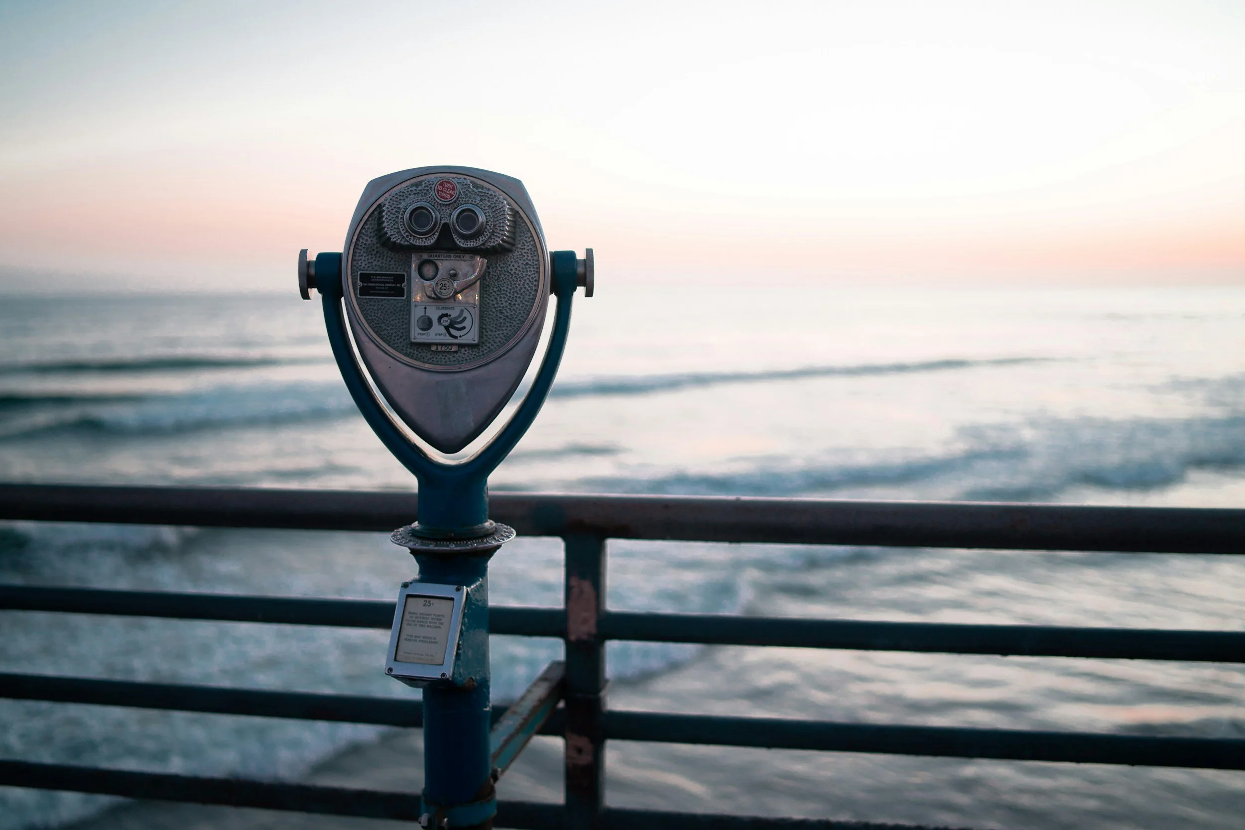 A viewing scope on a pier, symbolizing reflection, self-awareness, and observing experiences with curiosity.