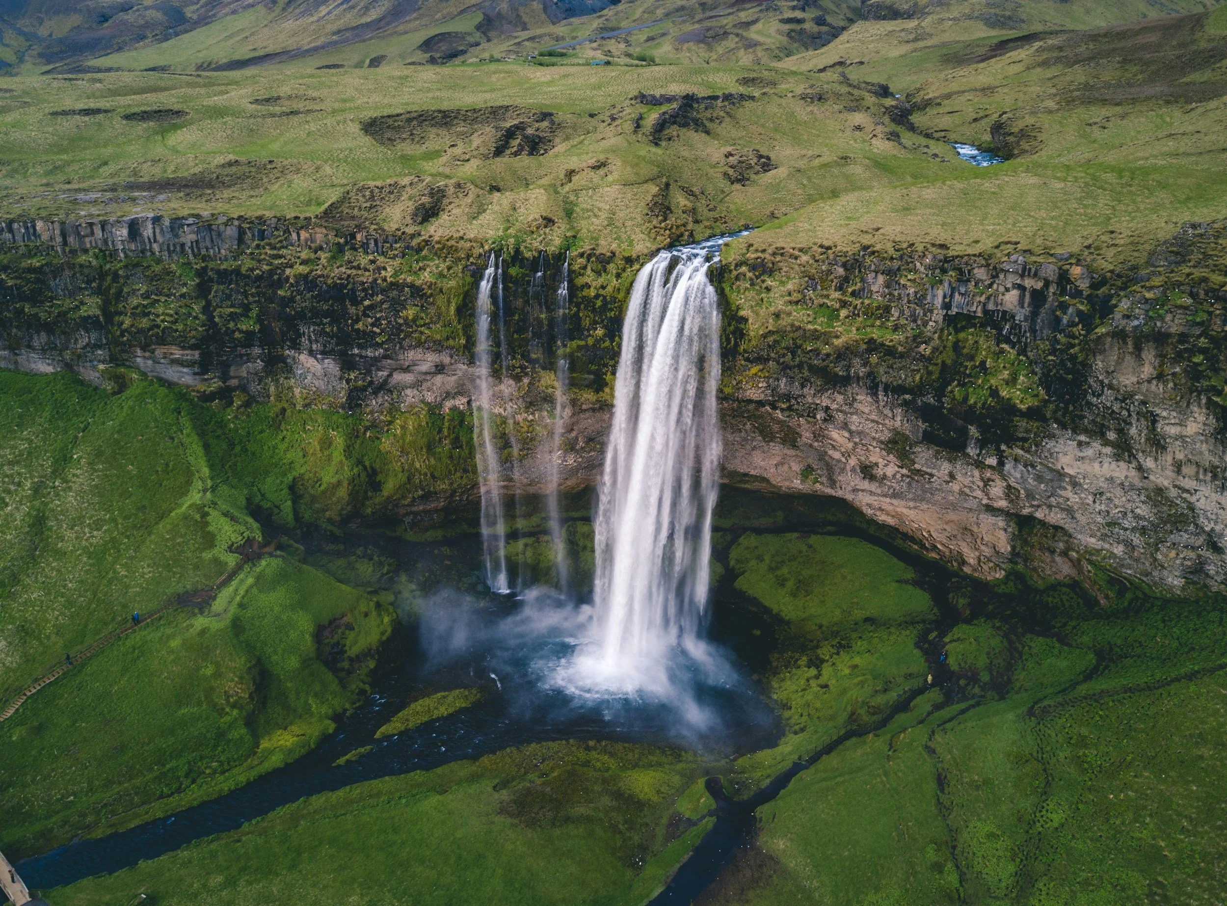 A waterfall viewed from above, representing emotional release, intensity, and movement during periods of stress or transition.