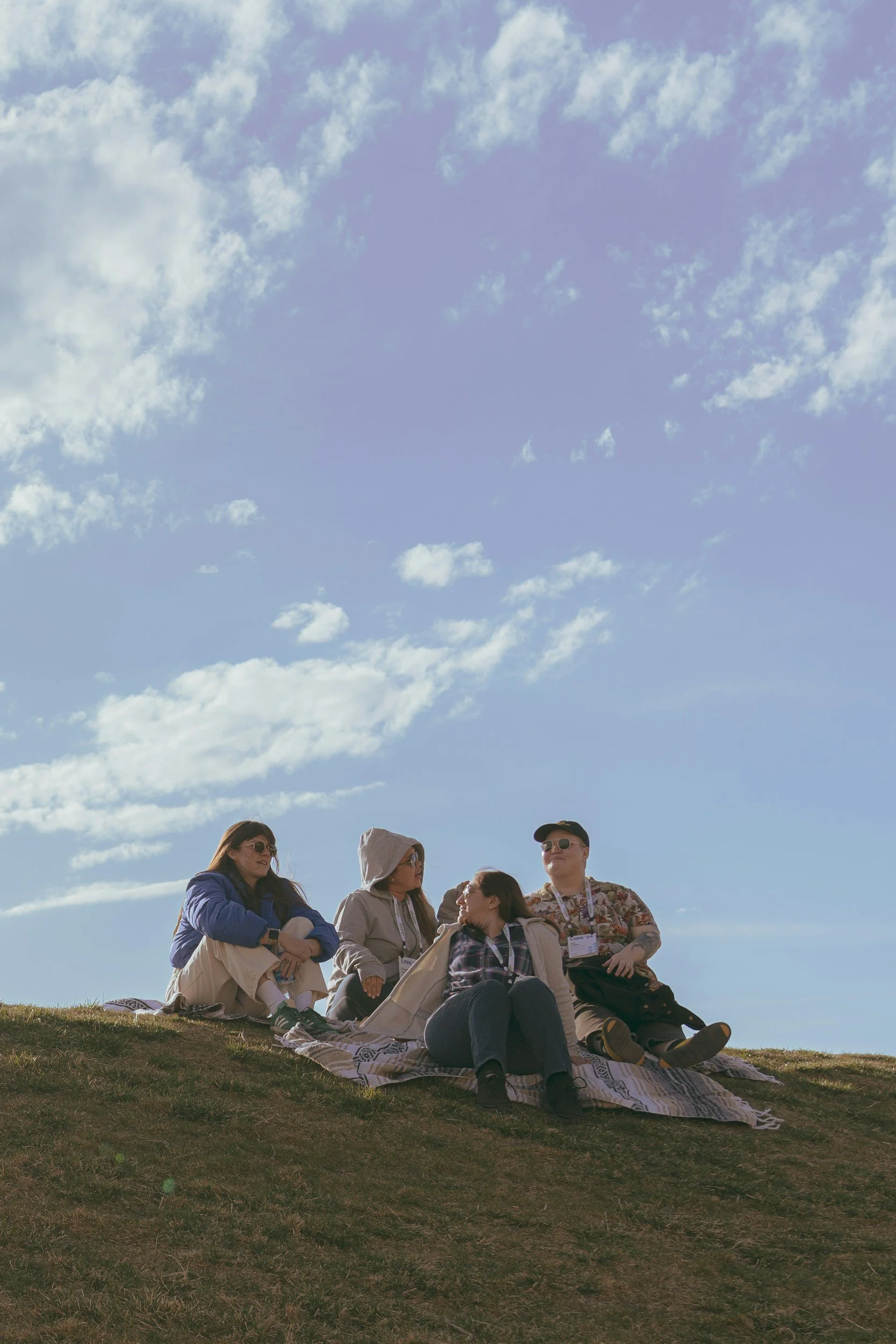 Teen sitting outdoors in a peaceful setting, representing therapy for anxiety, emotional regulation, self-esteem, and adolescent mental health support in Colorado.