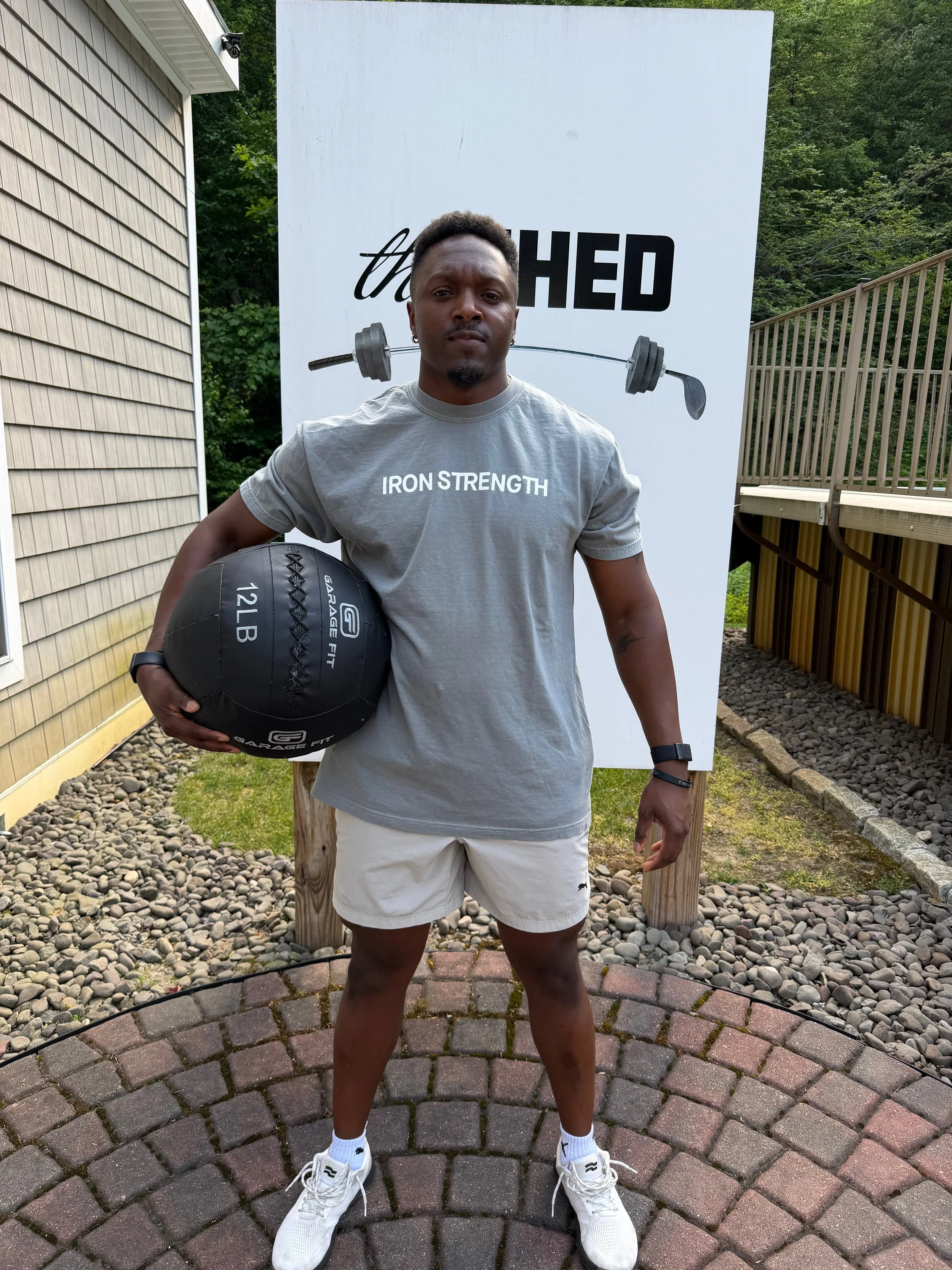 personal trainer holding wall ball