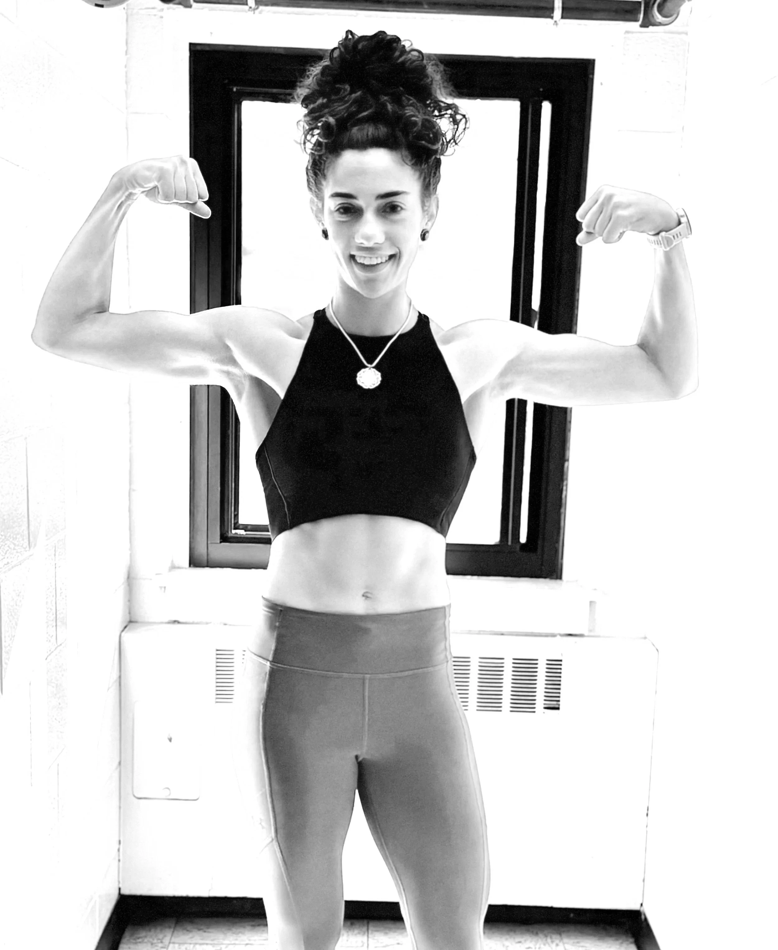 woman flexing to show off results of personal training program