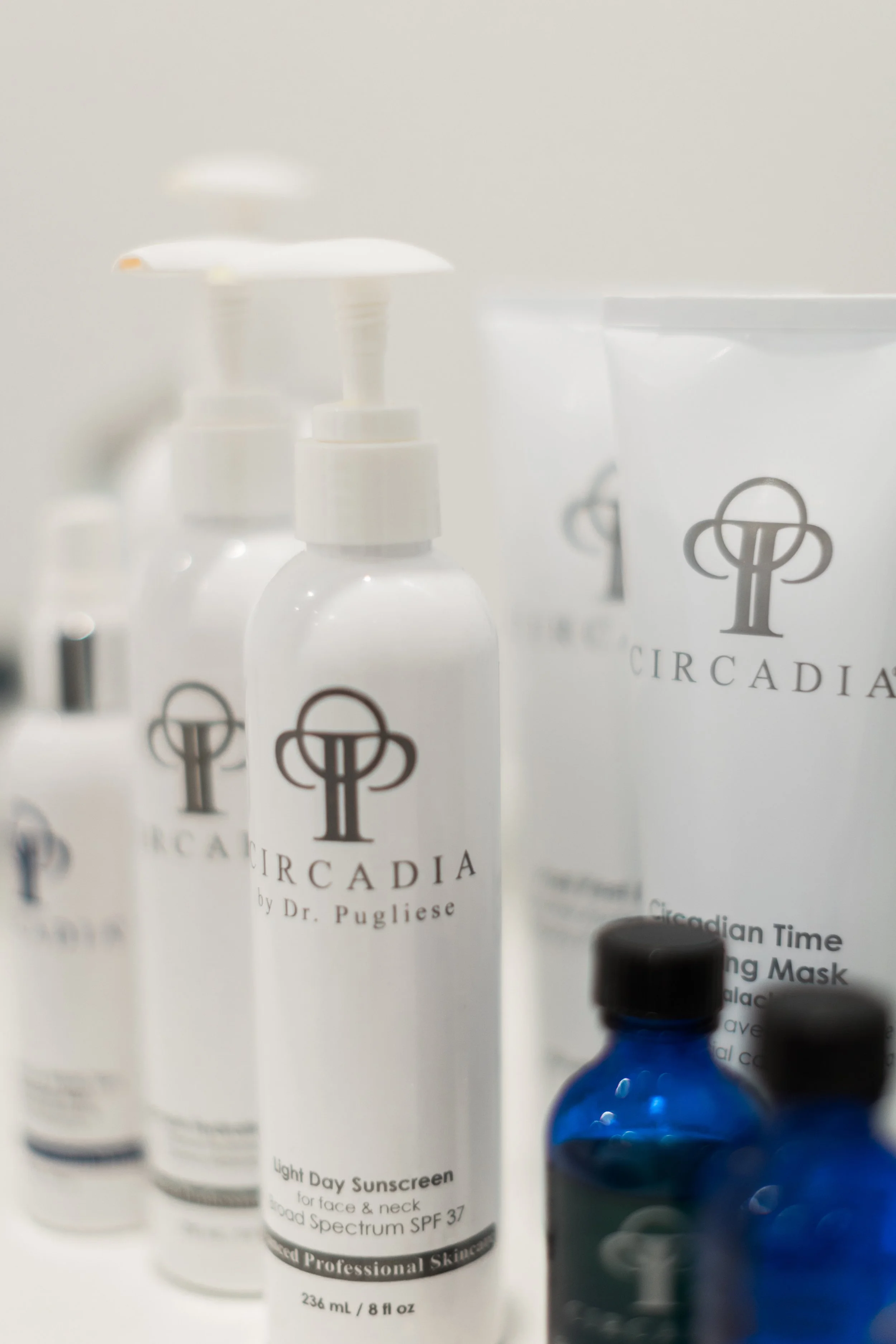 Collection of skincare and sunscreen bottles, including Circadia by Dr. Pugliese, displayed on a white surface.