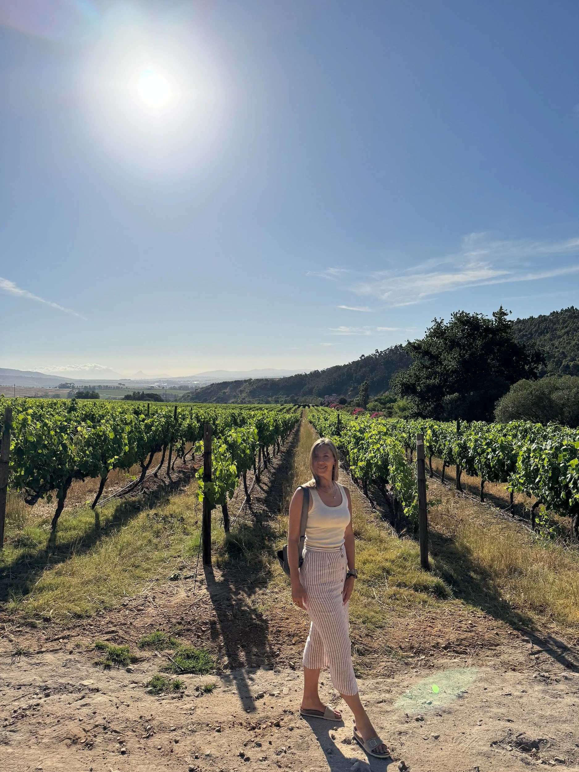 Woman standing in front of a vinyard