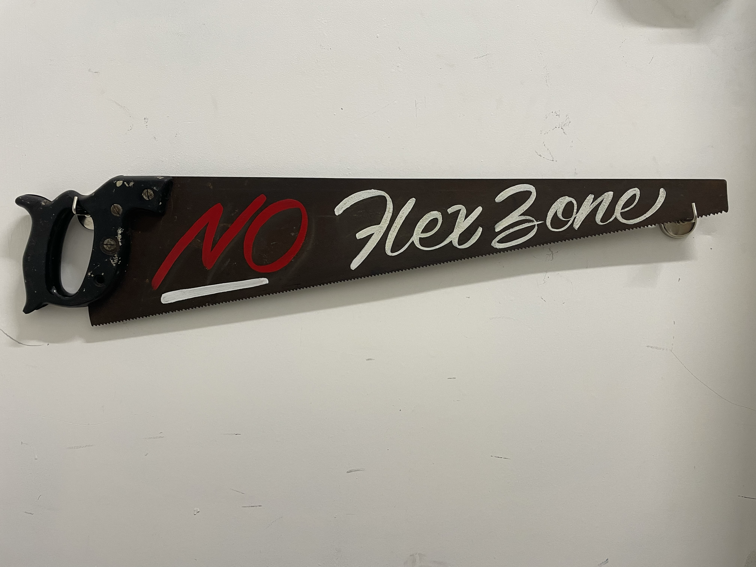 "No Flex Zone" - enamel on rusted handsaw