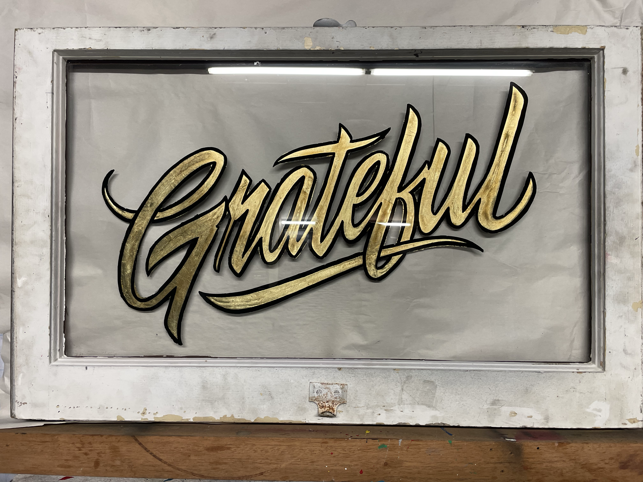 "Grateful" - reverse gold leaf on repurposed window pane