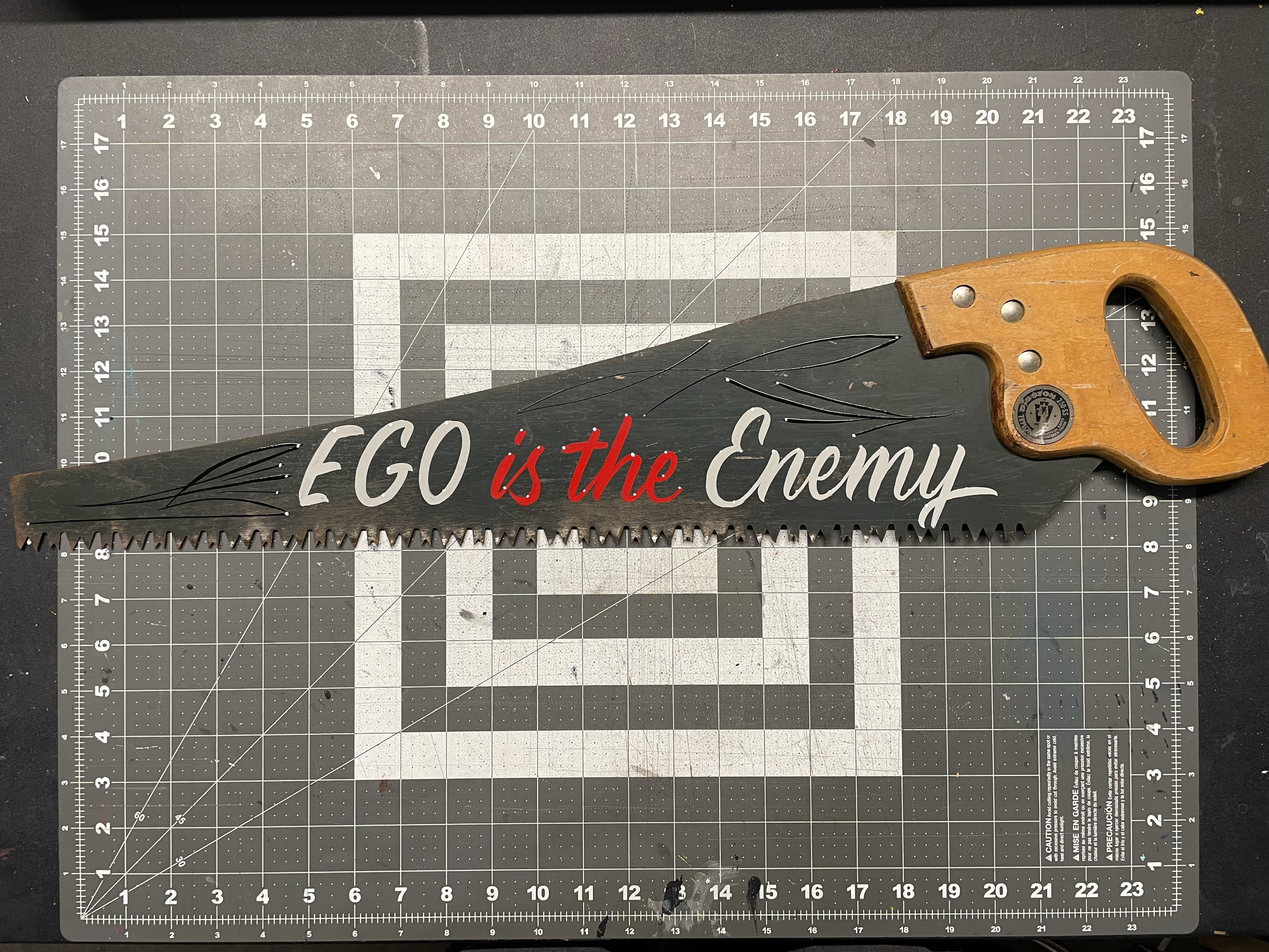 "Ego is the Enemy" - enamel on rusted handsaw