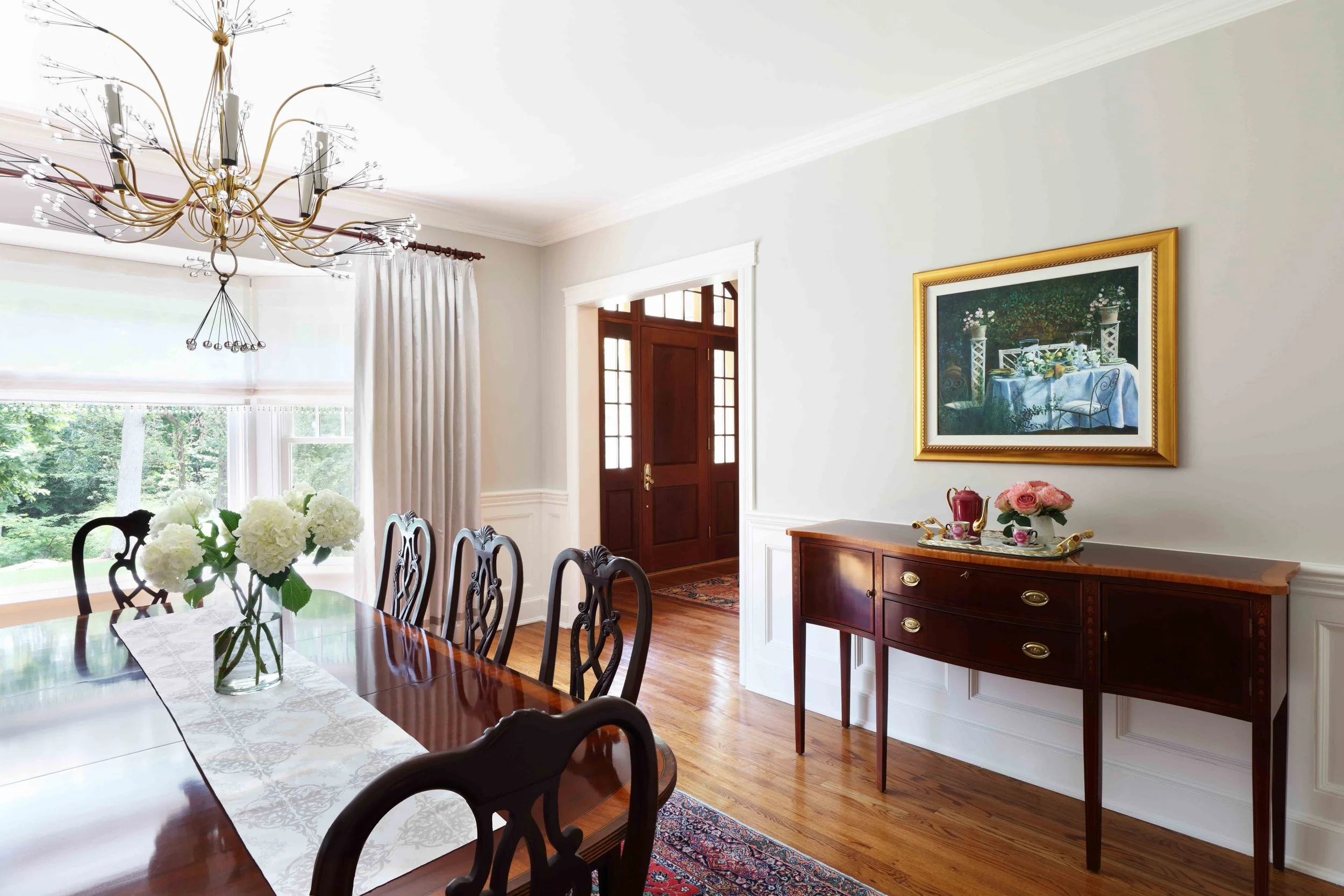 Dining Room featuring server and view to foyer at Lismore House in Greenwich, CT by Luminosus Designs.