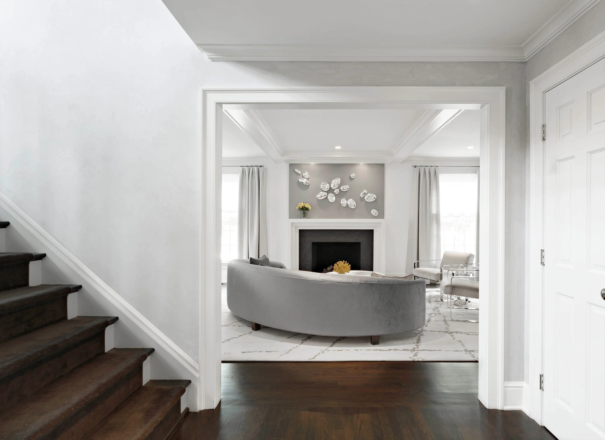 View into the living room at the Meeting House in Greenwich, CT highlighting architectural trim and a fireplace-centered layout.