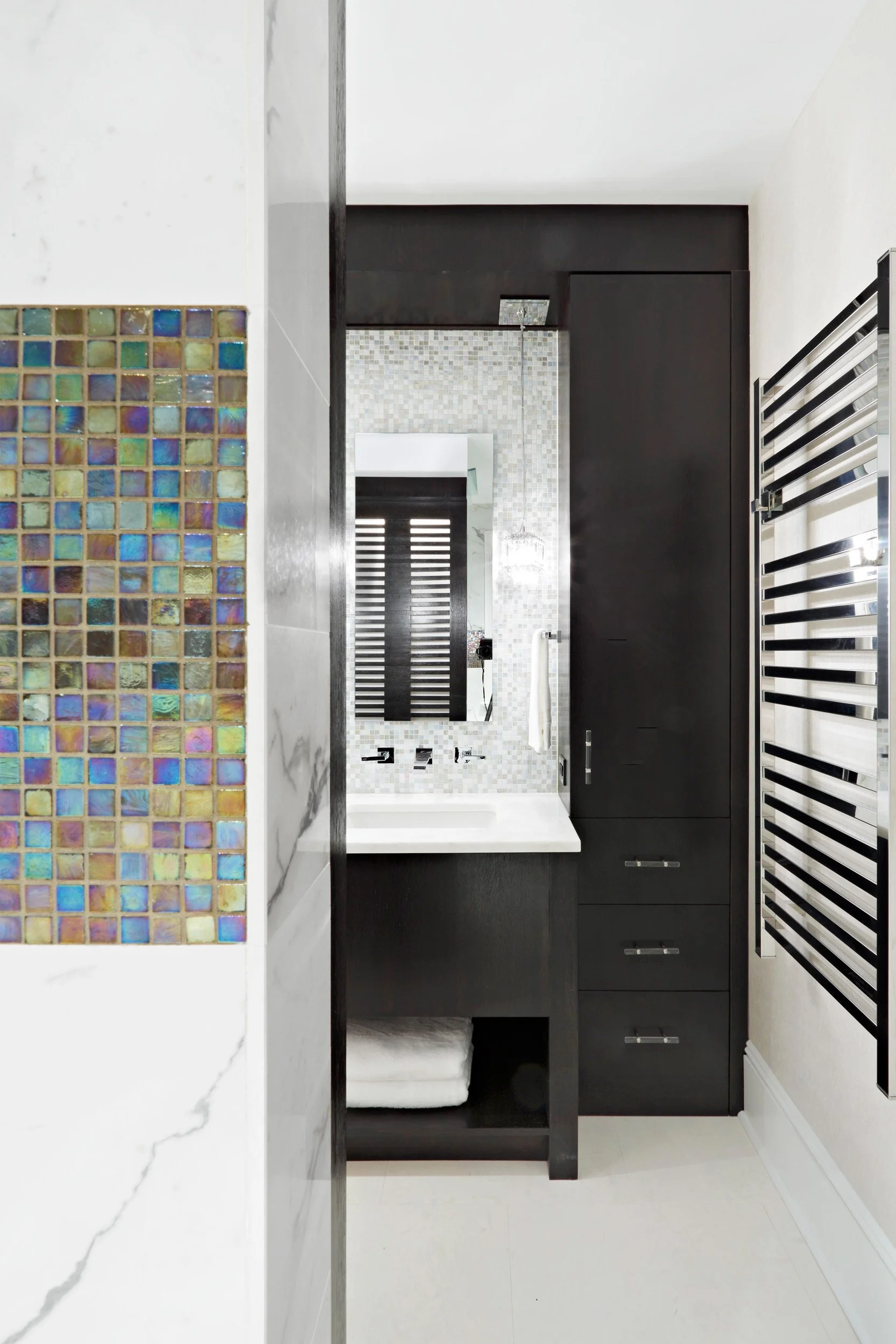 close-up view of the shower and vanity in a primary bathroom in Old Briarcliff, NY.