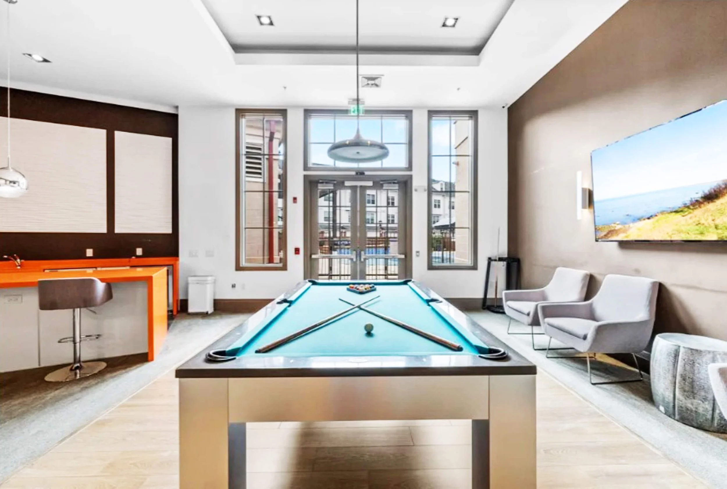 Residential lounge seating with layered textures and durable finishes in Bayonne NJ apartment building.