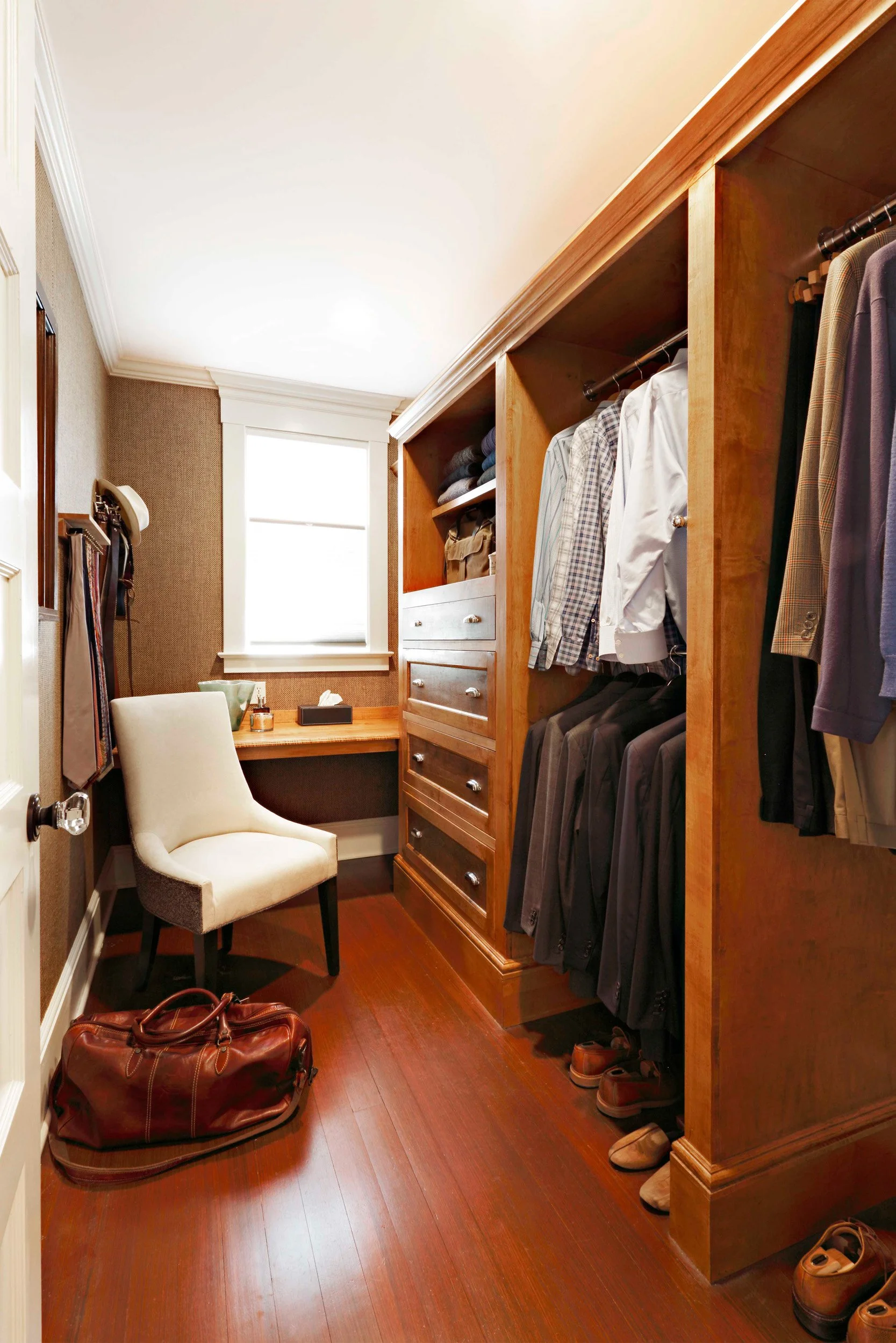 Custom His closet in Indian Field residence in Greenwich, CT designed by Luminosus Designs with tailored storage.