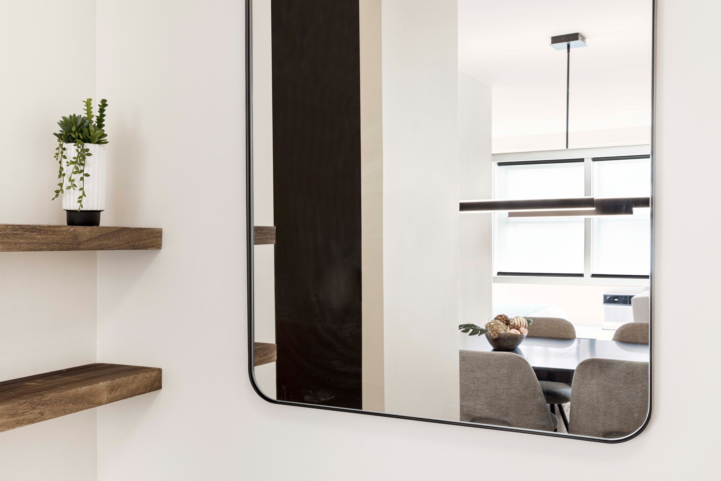 Detail view of foyer mirror and shelving in the Gramercy Arms apartment.
