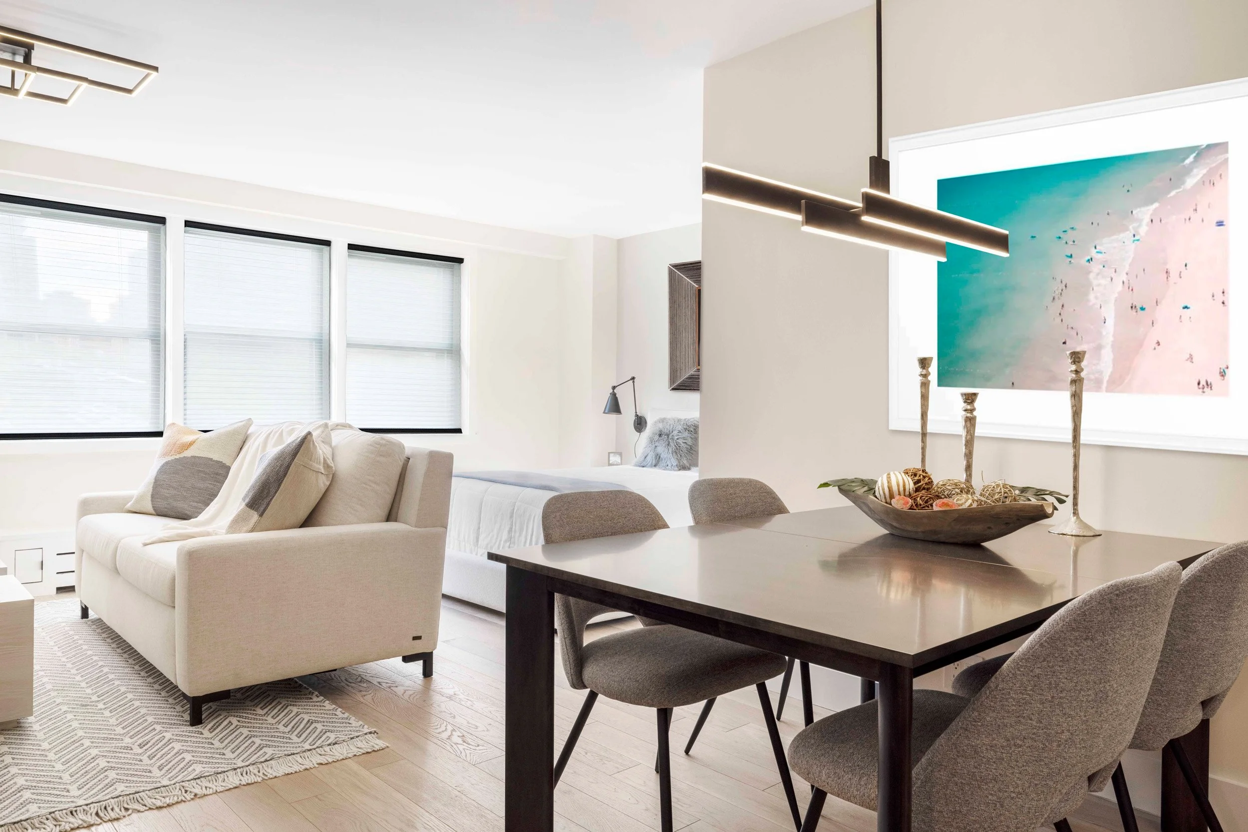 Wide view of the dining area looking into adjacent living area in the Gramercy Arms apartment NYC, showing table placement and circulation.