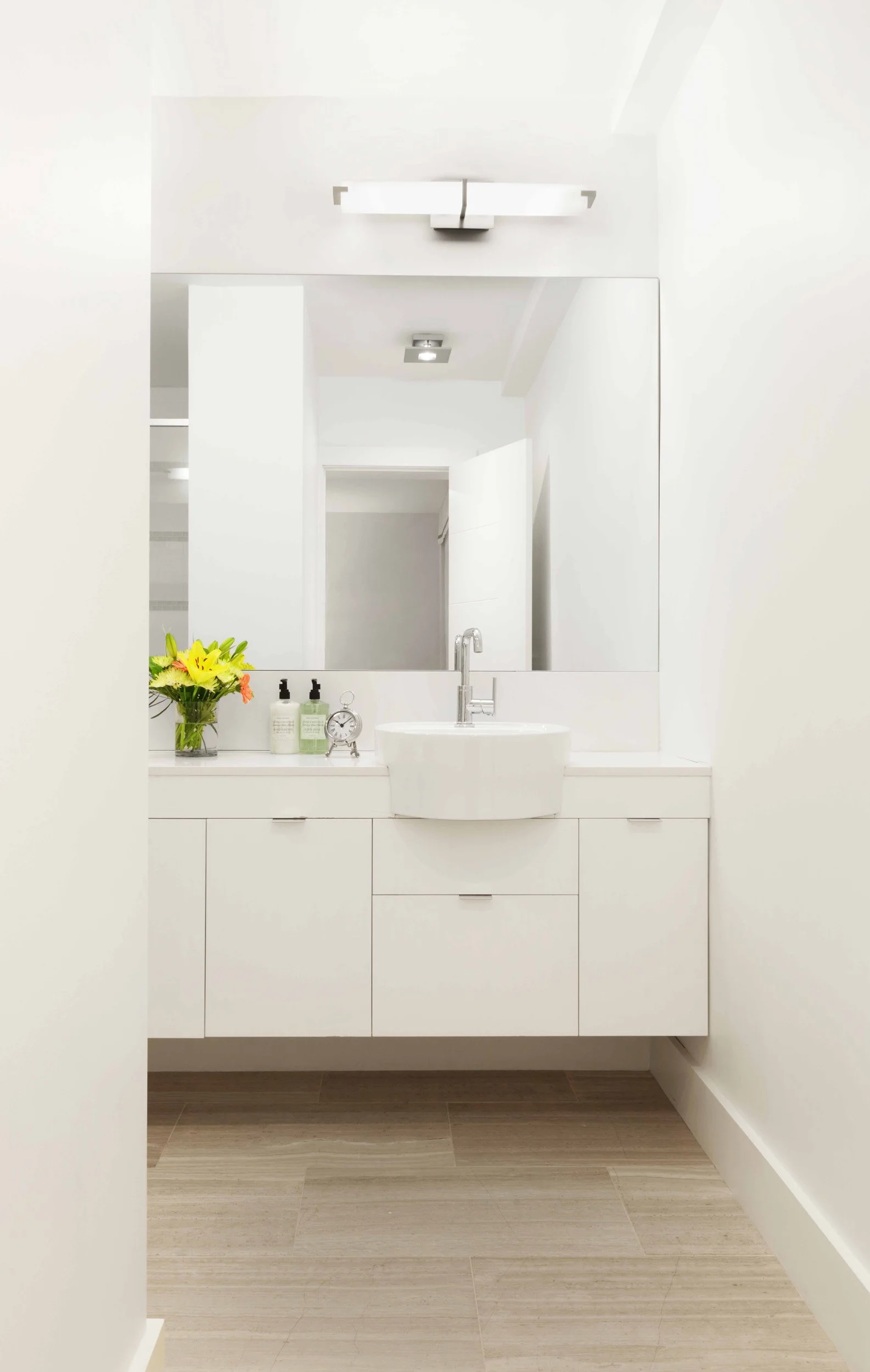 Modern primary bathroom with floating vanity, vessel sinks, and clean-lined finishes in Doyer Apartment in White Plains, NY.