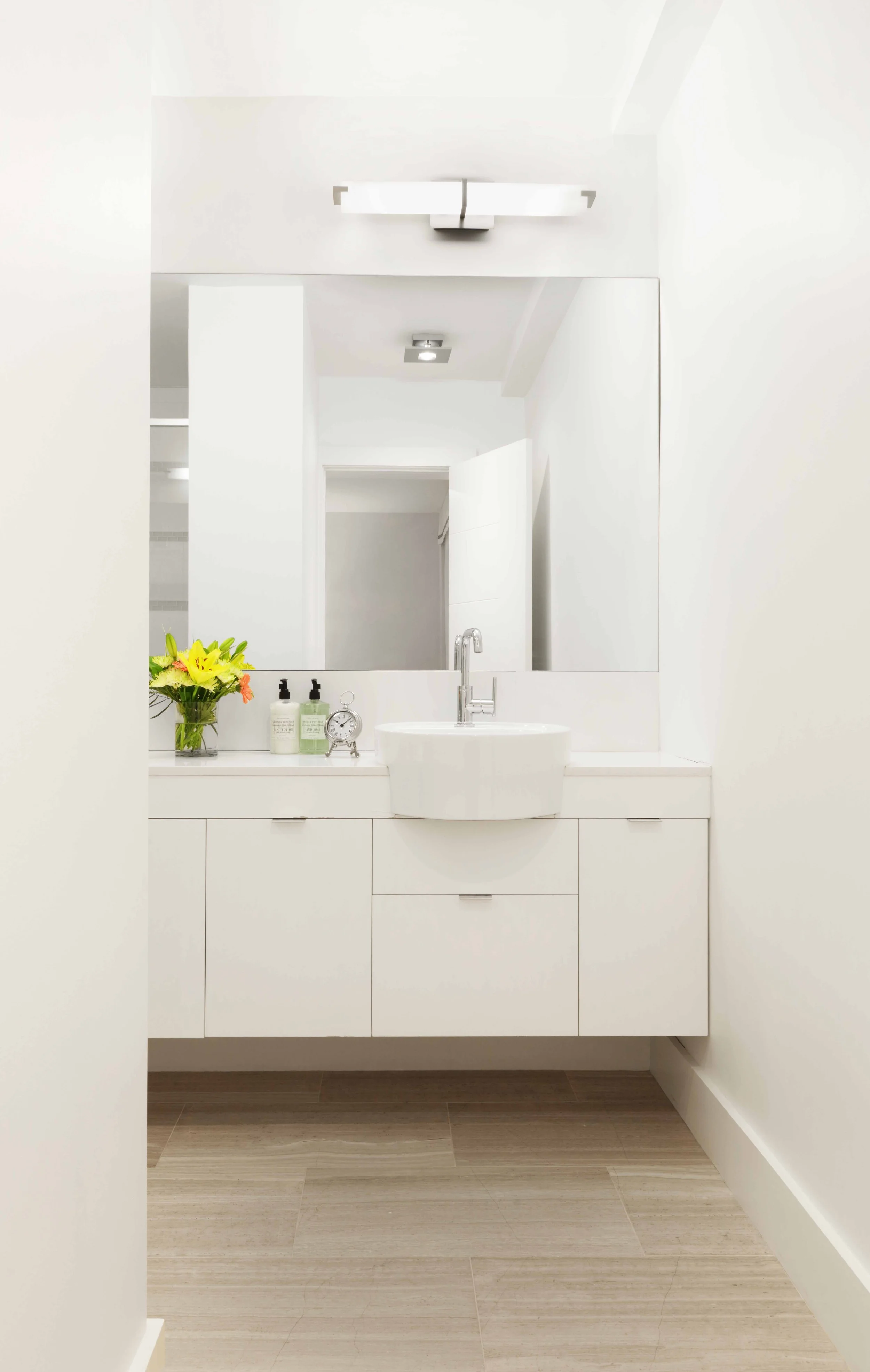 Modern primary bathroom with floating vanity, vessel sinks, and clean-lined finishes in Doyer Apartment in White Plains, NY.