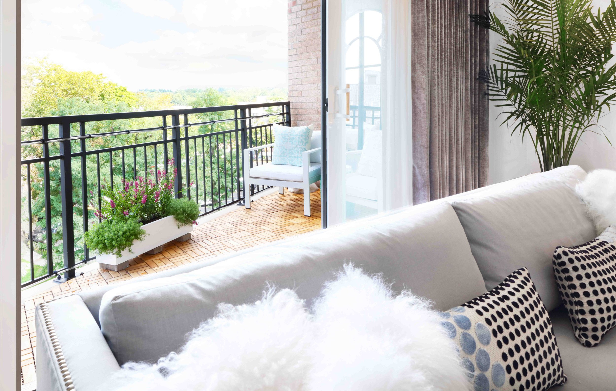 Private apartment balcony with seating and city views in Doyer Apartment in White Plains, NY.