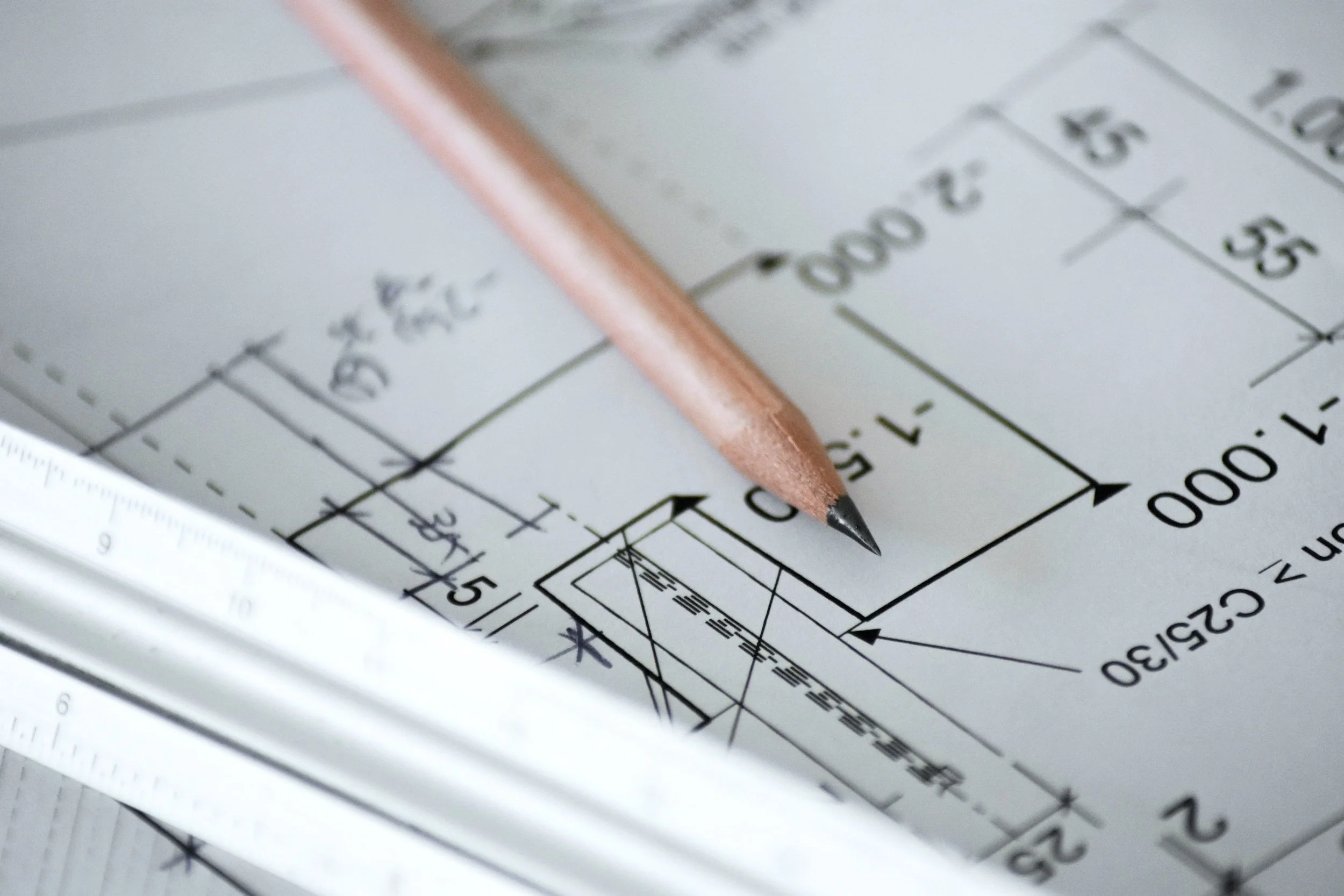 pencil on top of architectural drawings