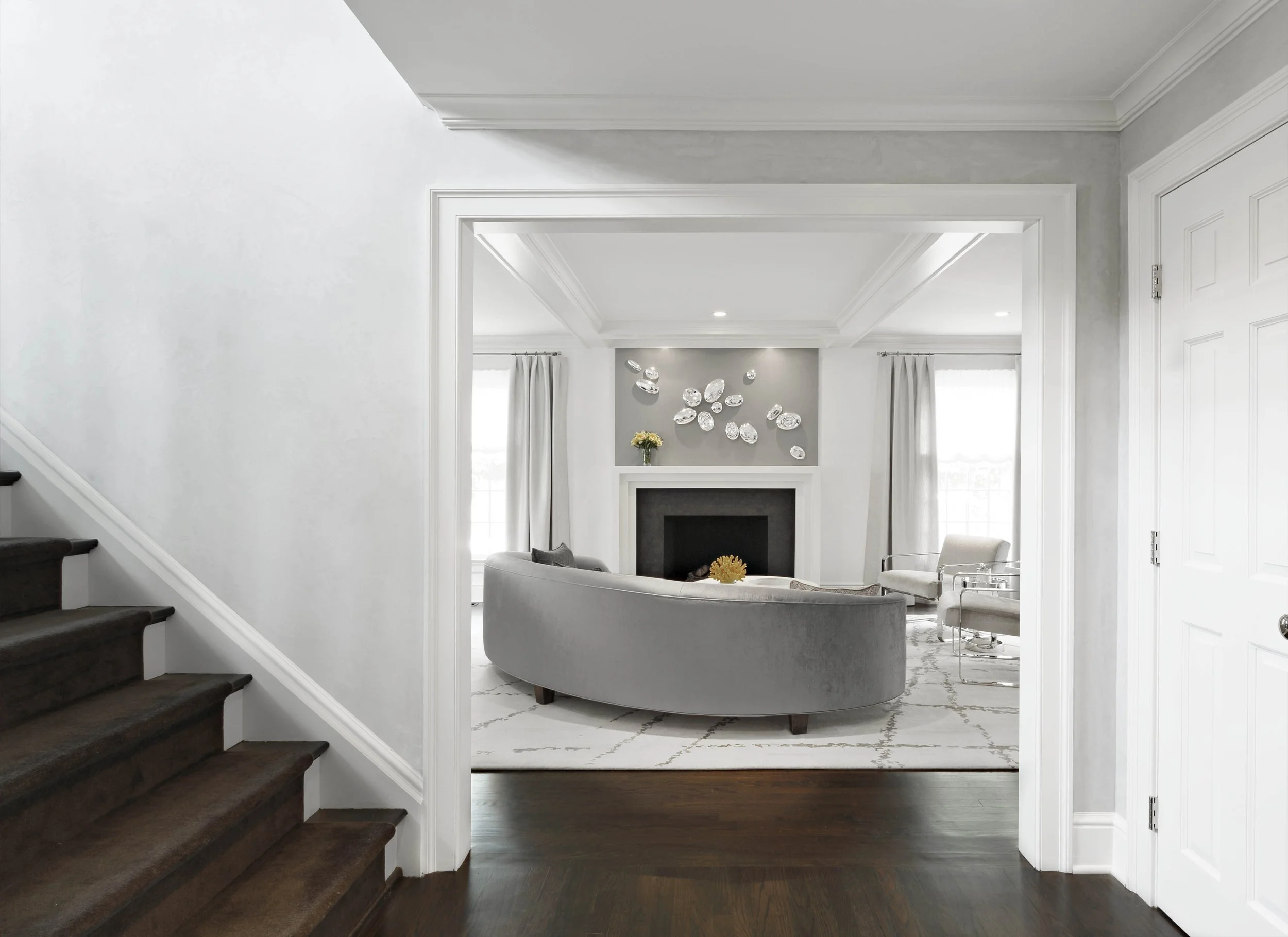 View into the living room at the Meeting House in Greenwich, CT highlighting architectural trim and a fireplace-centered layout.