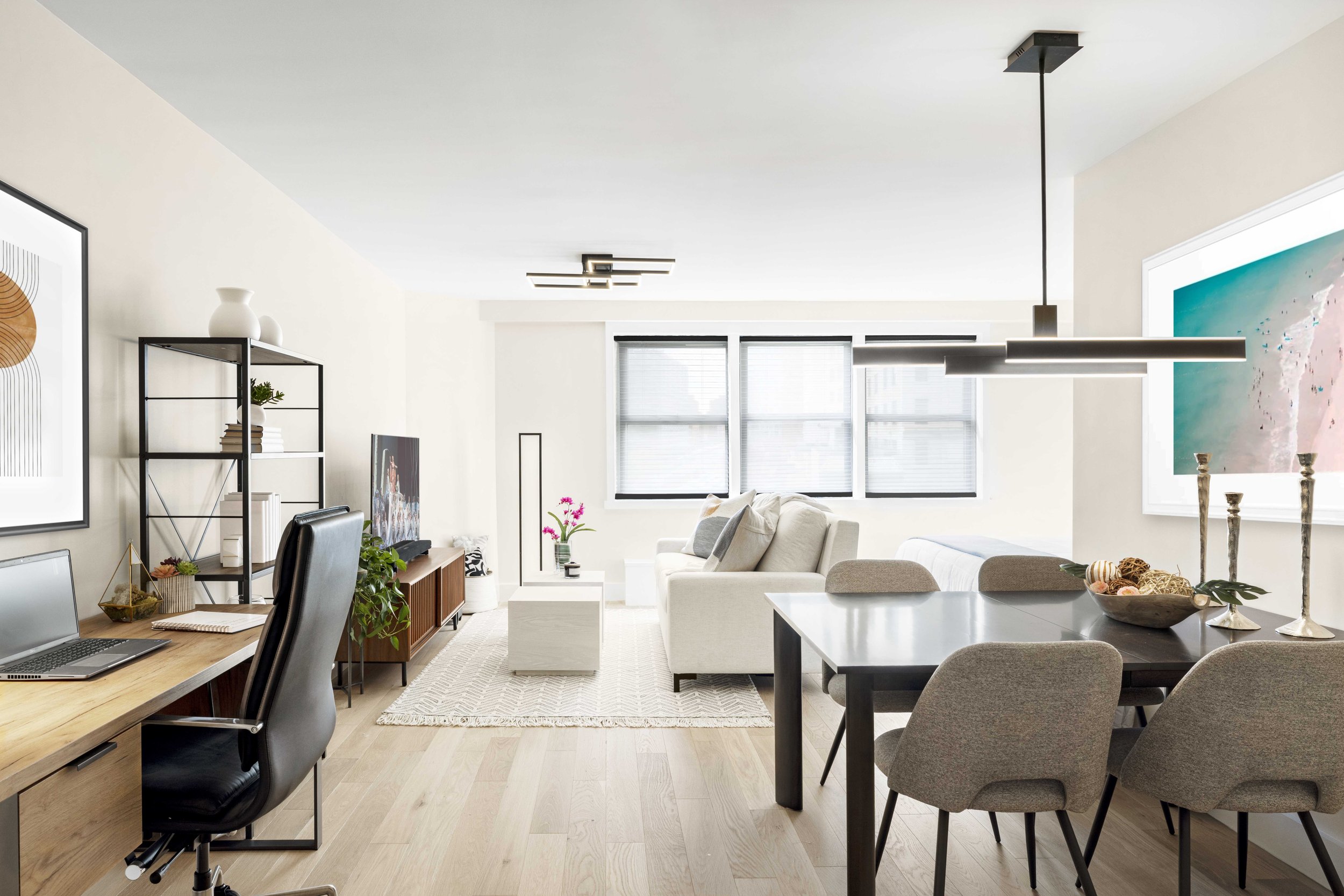 Wide view of the Gramercy Arms apartment in New York City, showing an open floor plan, tailored furnishings, and a calm, sophisticated aesthetic.