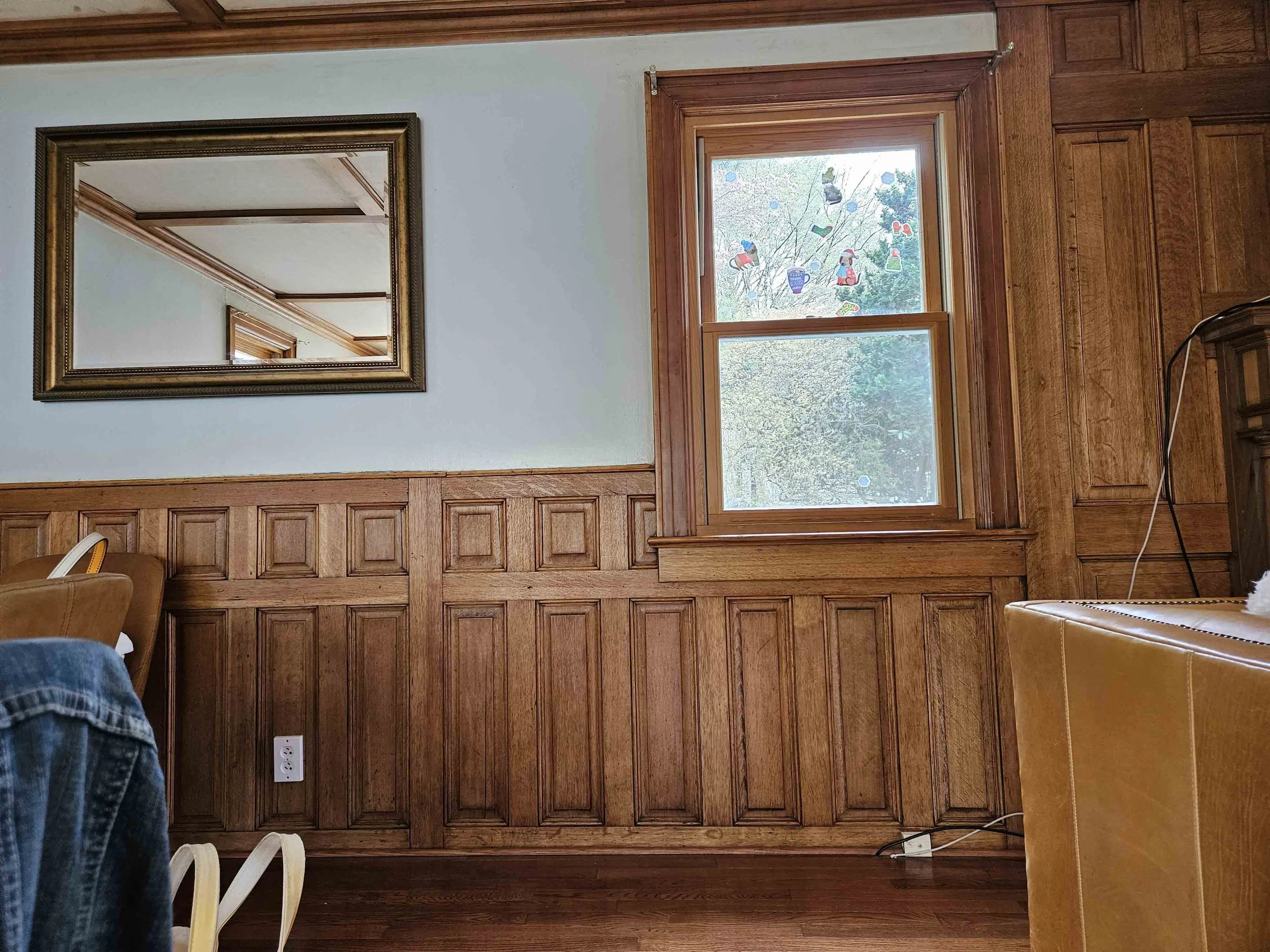 Before renovation, the dining room’s original wood paneling gave the room character, but the fireplace wall and overall feel needed updating.
